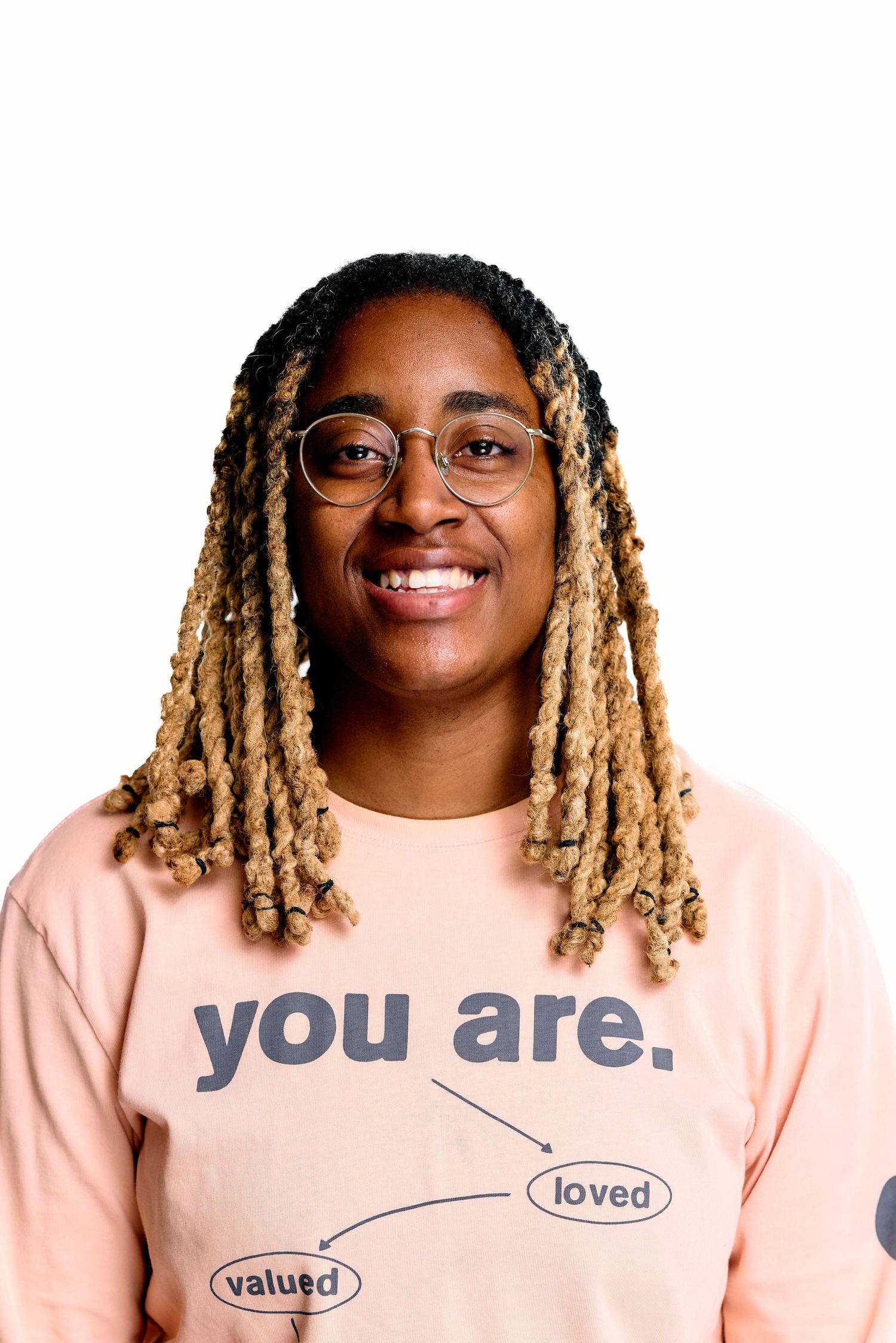 Pink t-shirt with inspirational text 'you are loved valued' displayed against white background.