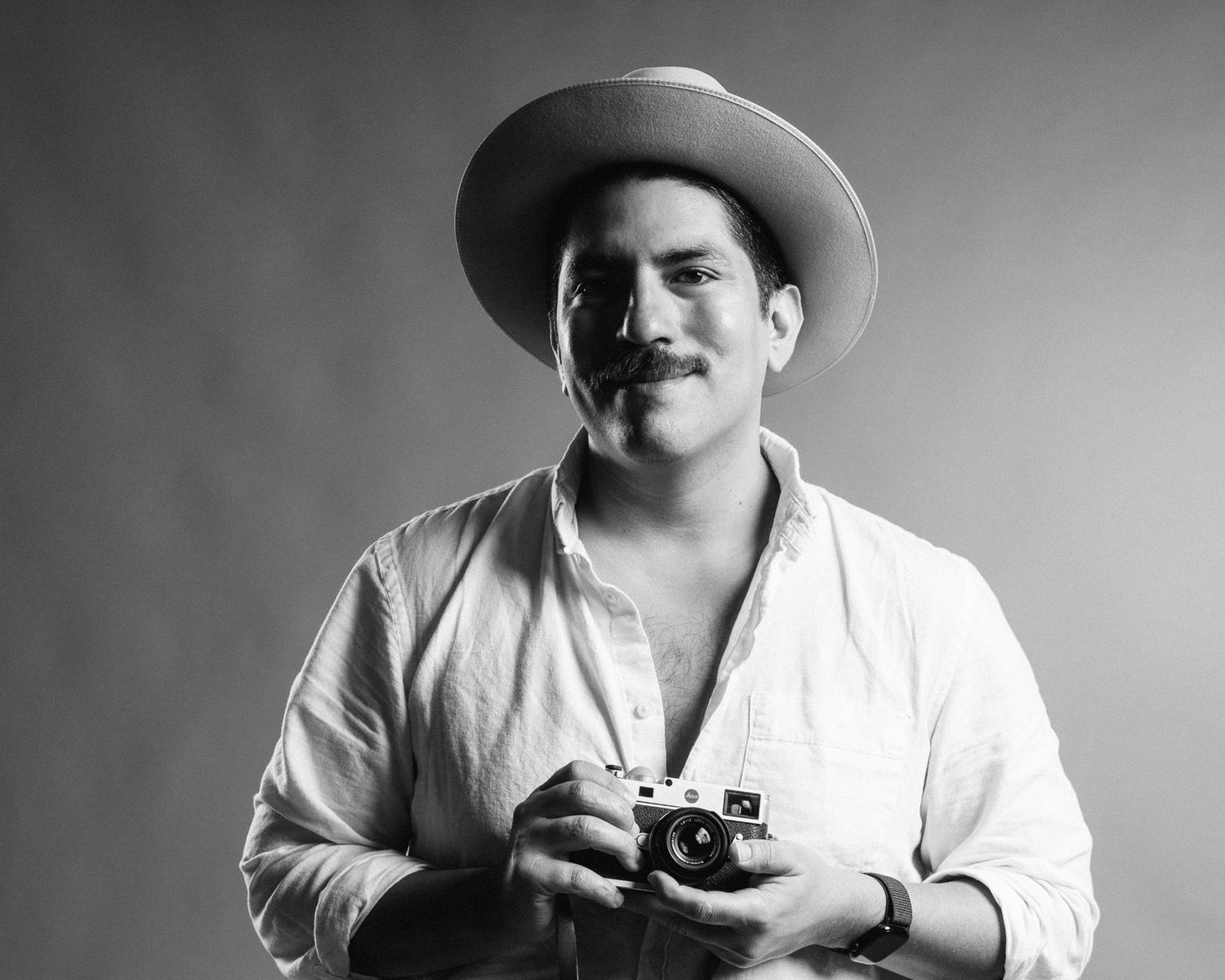 A series of black and white portraits showing someone in a cowboy hat posing with different expressions and gestures.