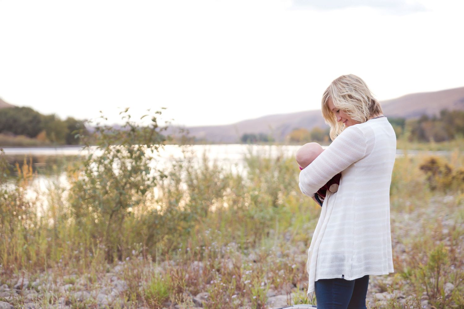 Candid family moments captured in golden sunlight against mountain landscape.