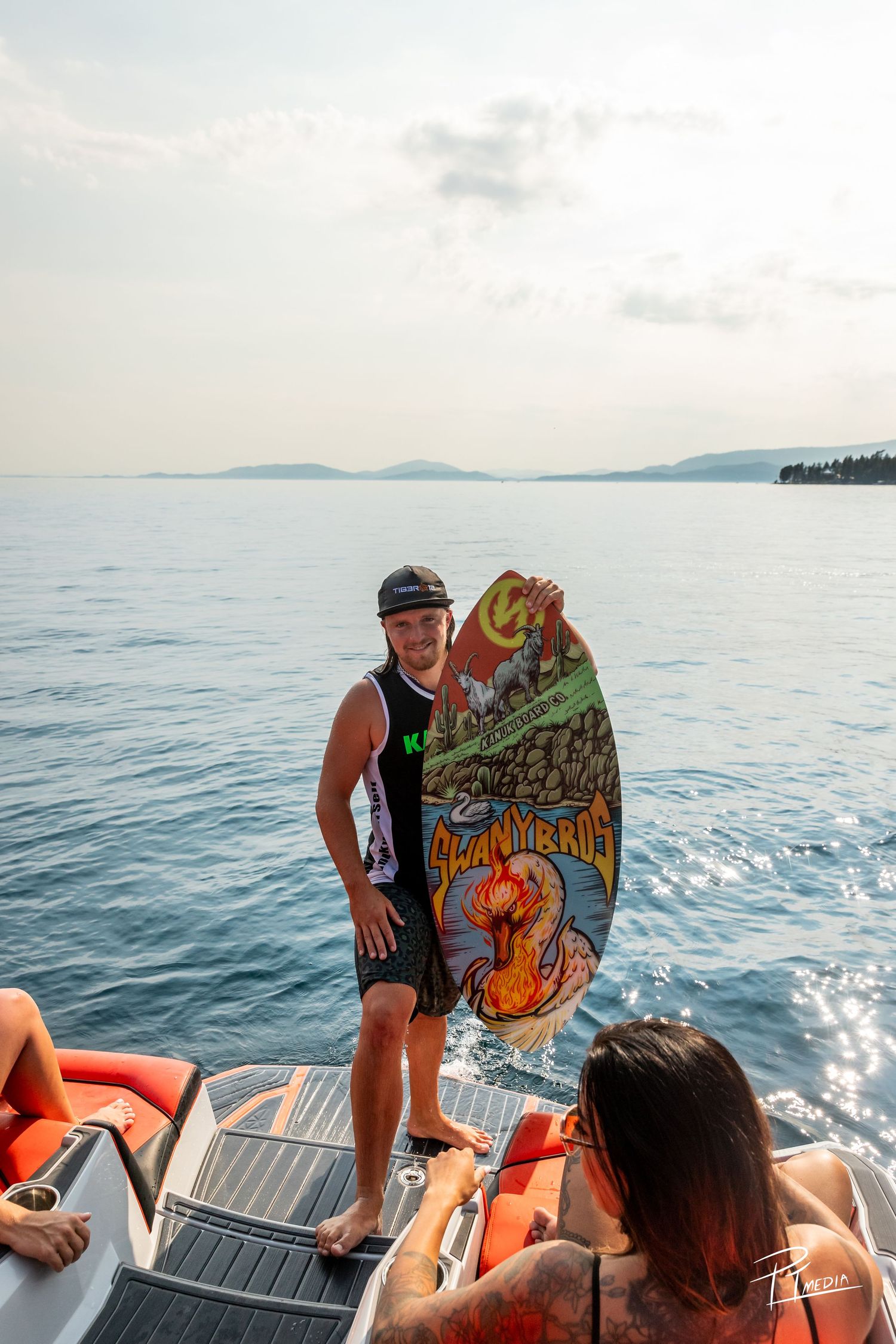 People enjoying a boat ride on calm ocean waters while holding up decorated Halloween pumpkin art pieces.