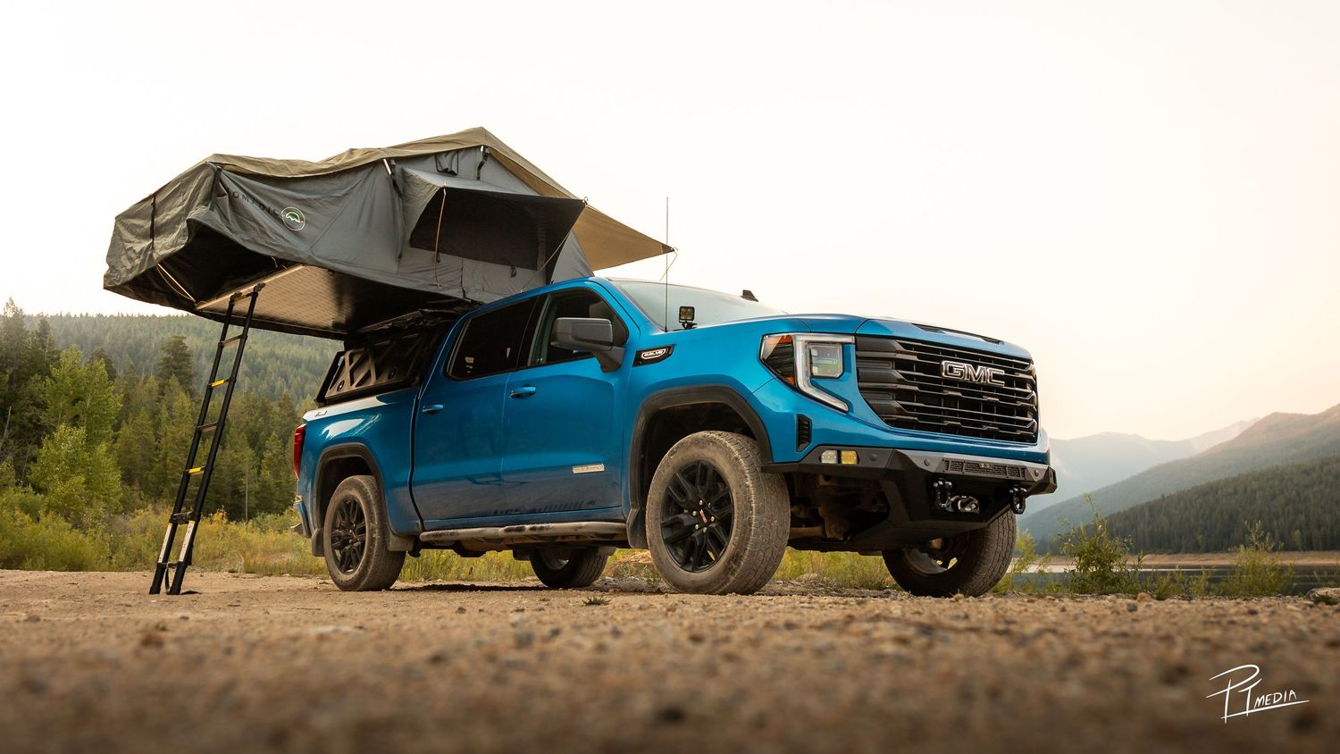 A collection of blue pickup trucks photographed at sunset in various rugged outdoor settings.