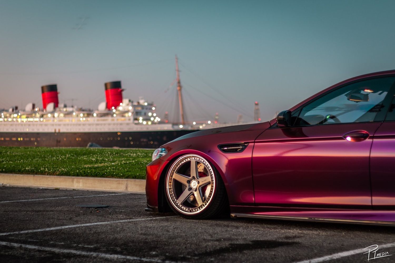 A purple Chevrolet Corvette parked in various scenic locations showcasing its sleek profile and custom wheels.