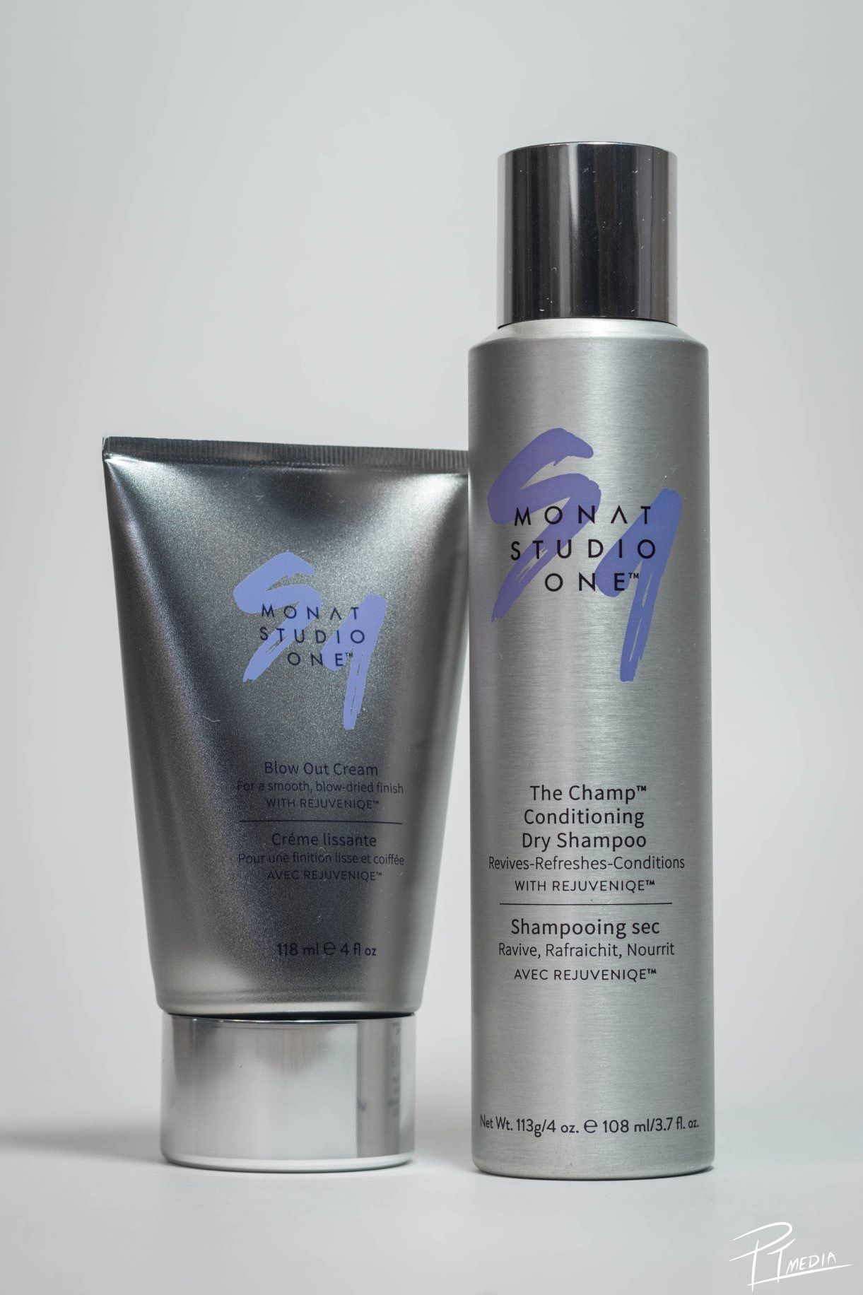 Collection of silver Monat Studio hair care product bottles and containers arranged in a minimalist product display.