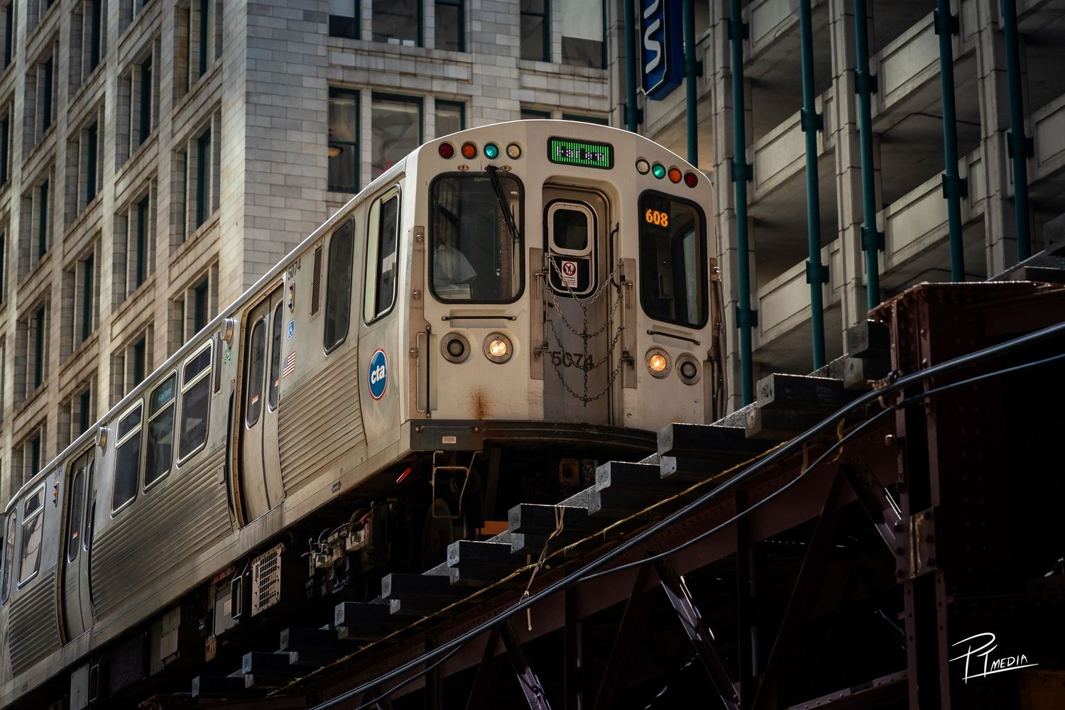A vintage subway train car moves through an urban tunnel with dramatic lighting and reflective surfaces.