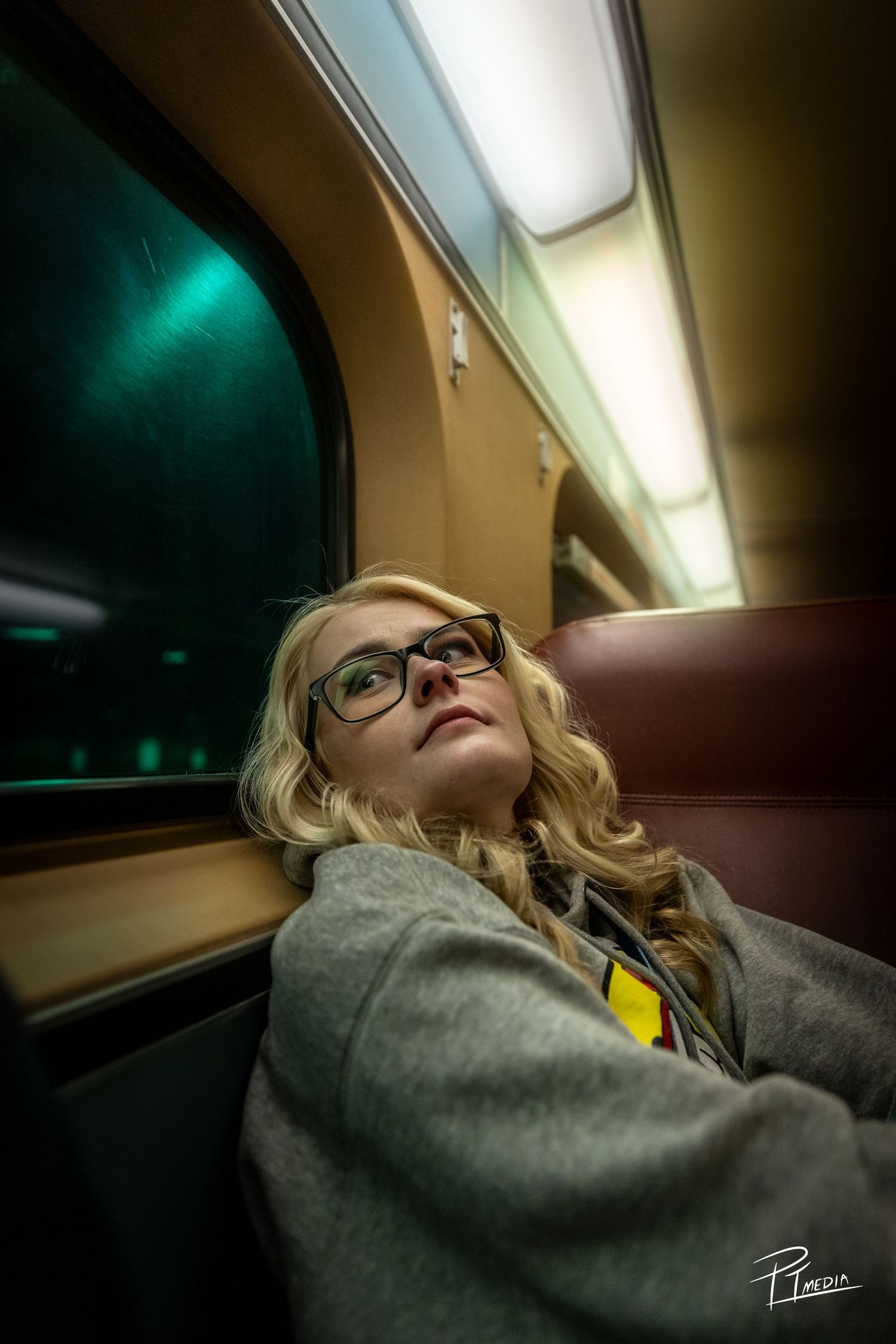 A passenger wearing glasses rests against a train window showing a progression of sleeping positions during travel.