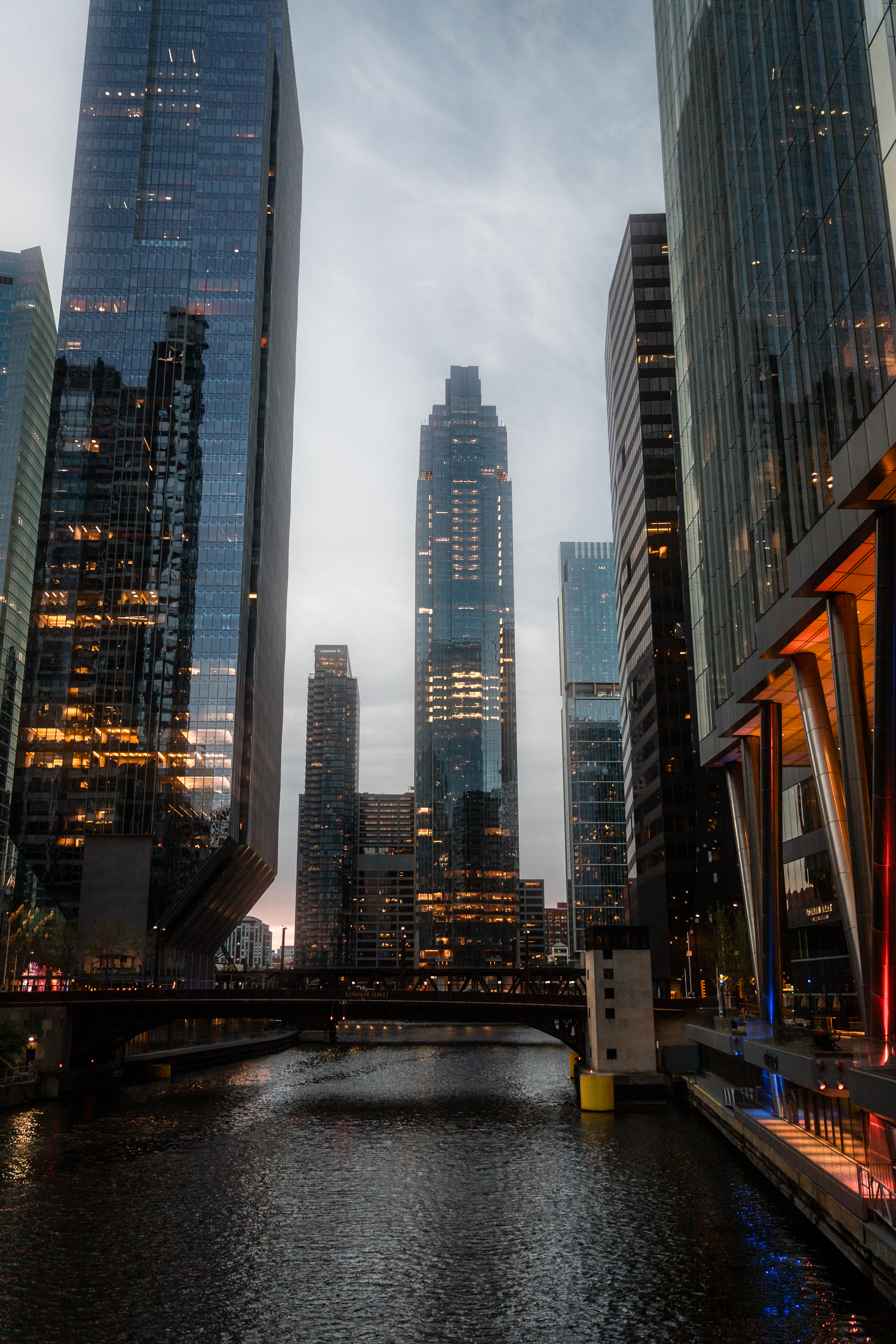 Downtown Chicago skyscrapers and river view at twilight with moody atmosphere.
