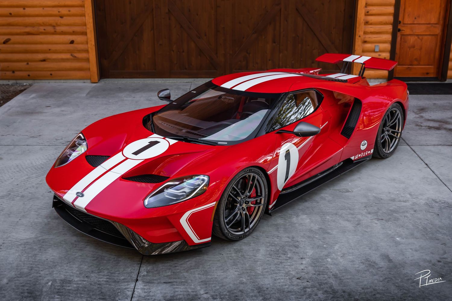 Red Ford GT sports cars with white racing stripes showcased in a series of connected images on a concrete floor.