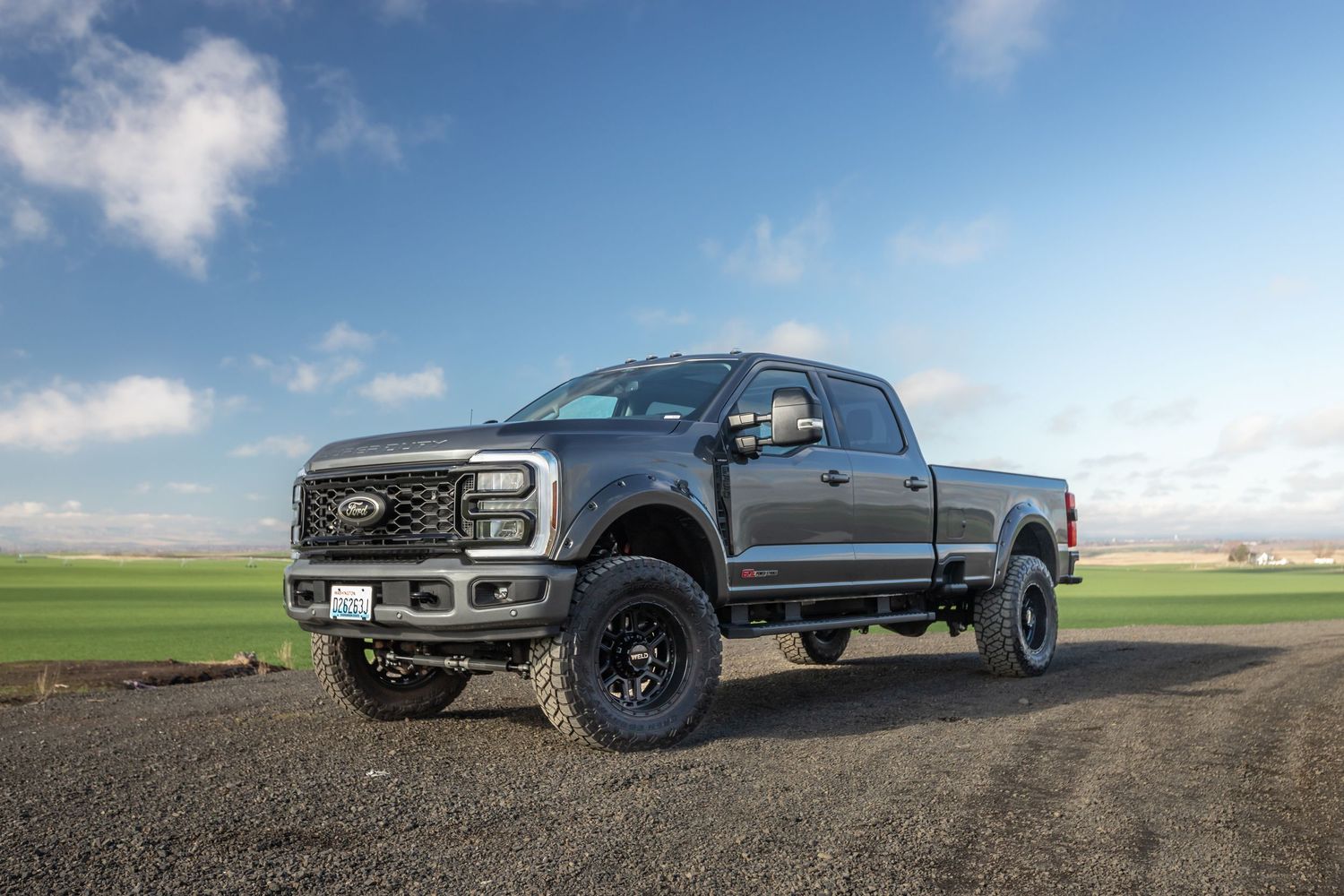 A lifted Ford pickup truck shown in multiple angles against scenic landscapes with blue skies and green fields.