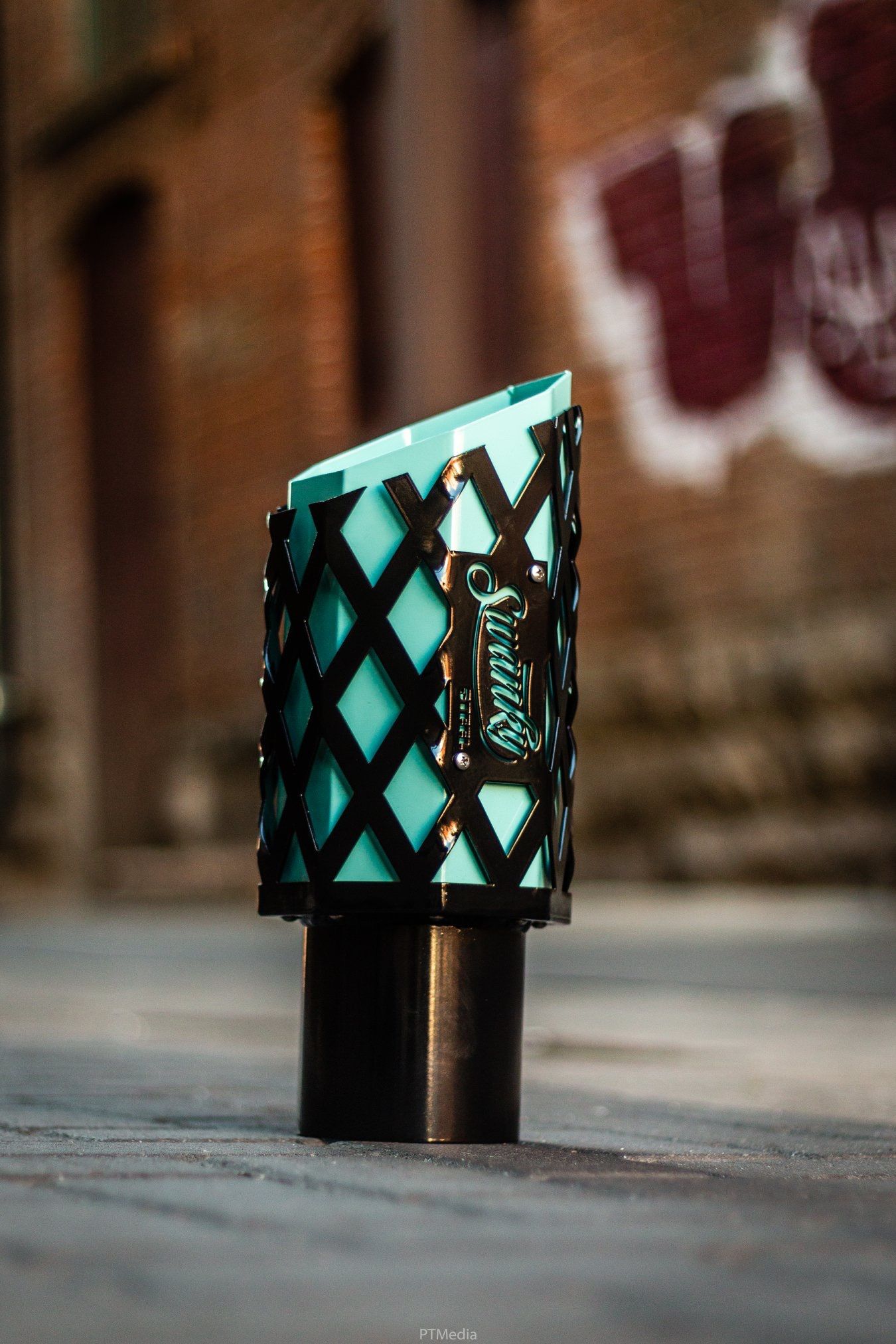 A sequence of photos showing a turquoise and black patterned ring displayed on a surface with a blurred brick wall background.