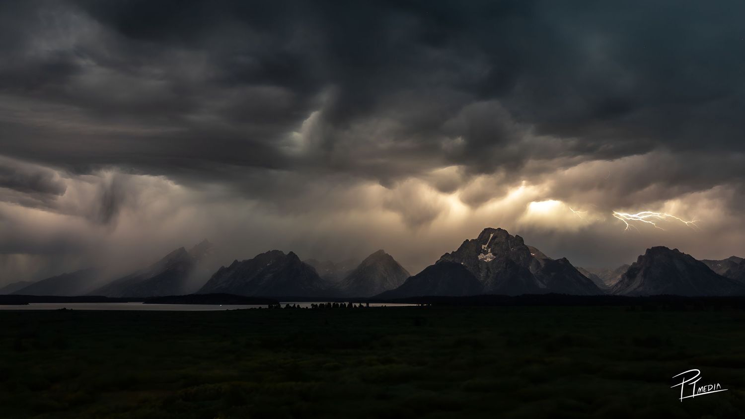 A dramatic panoramic series of dark storm clouds rolling over mountains at sunset creating an ominous atmosphere.