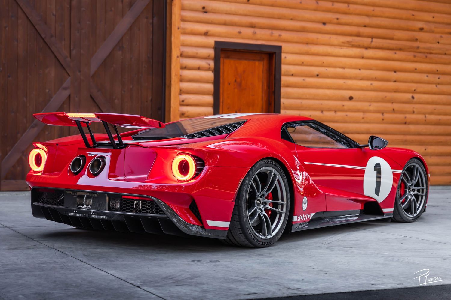 A red Ferrari racing car photographed in sequence from multiple angles against a wooden garage backdrop.