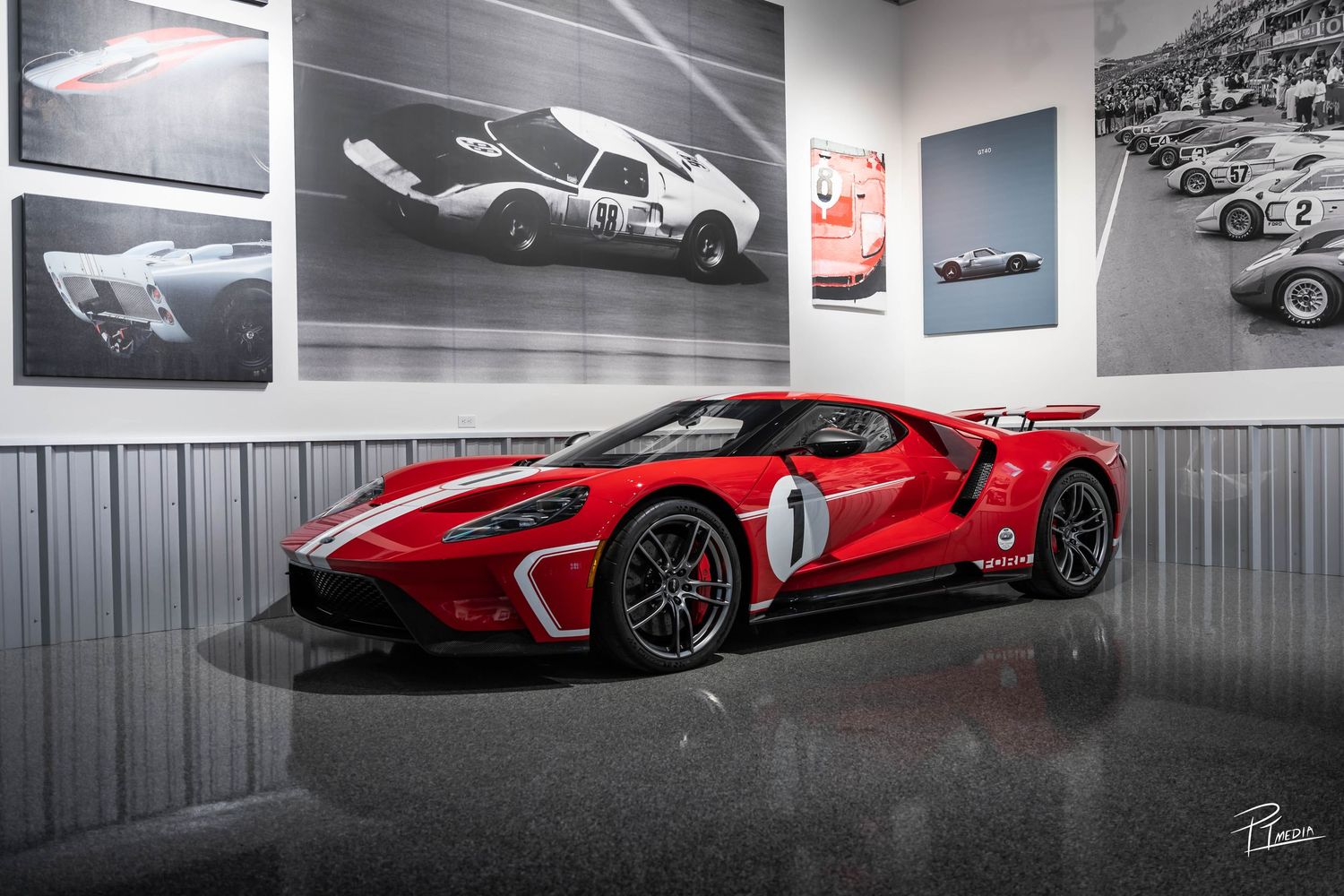 A collection of luxury sports cars including Ferrari and other supercars displayed in a modern showroom setting.