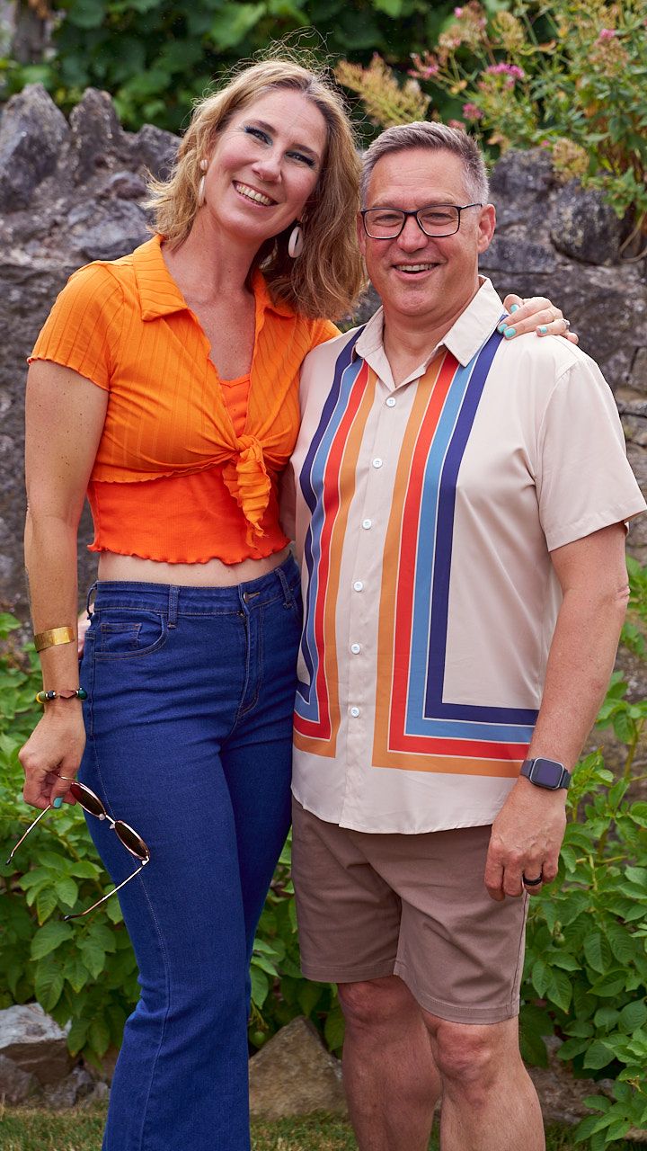 An outdoor photo showing two people posing together in orange and beige outfits against greenery, in anticipation of attending a Disco.