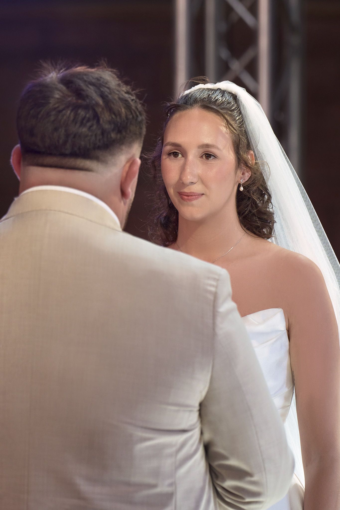 Bride looking at the groom during their wedding ceremony.