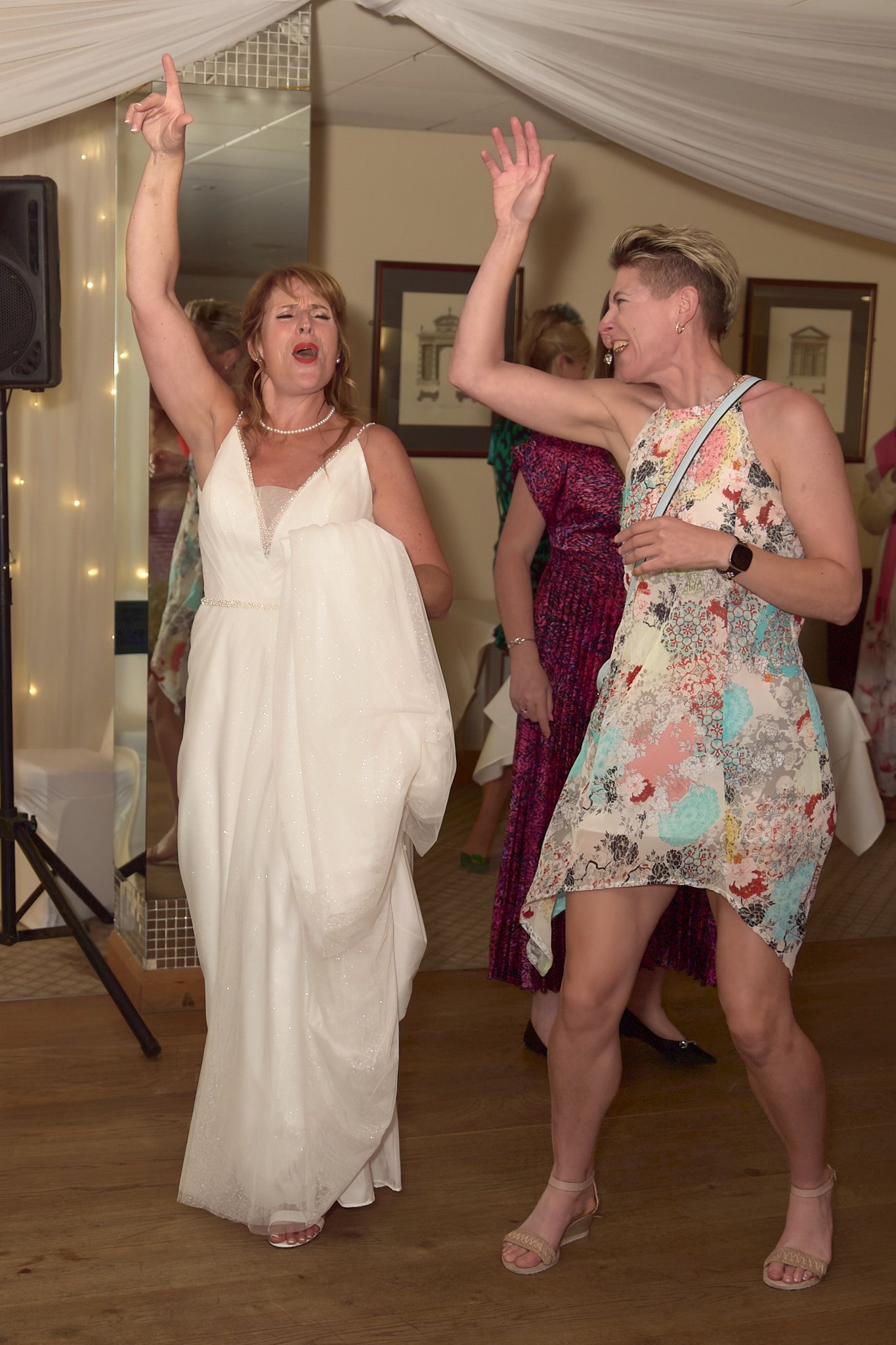 Bride dancing with a guest during the wedding reception.