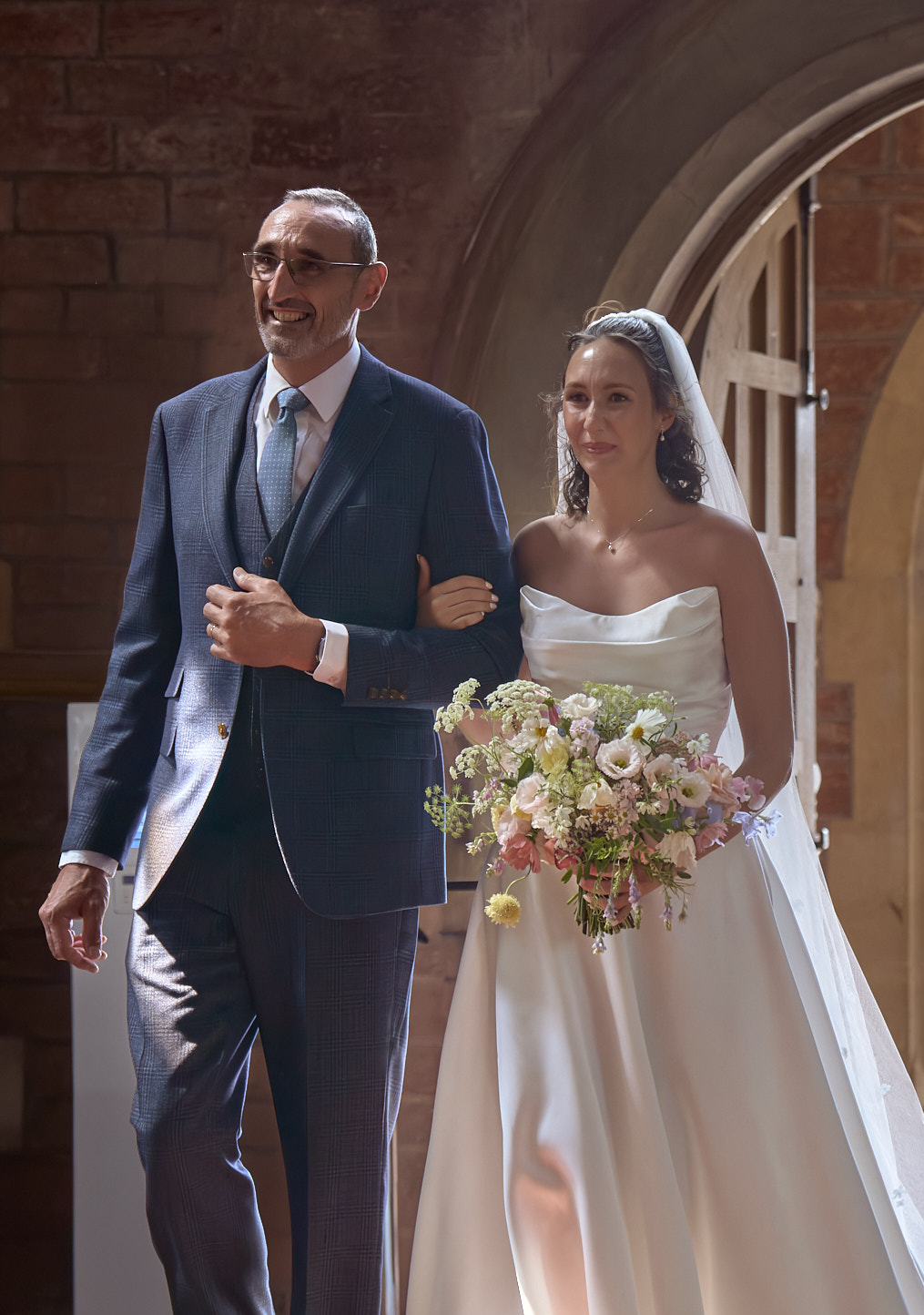 Bride entering the church with her father at the start of the wedding ceremony.