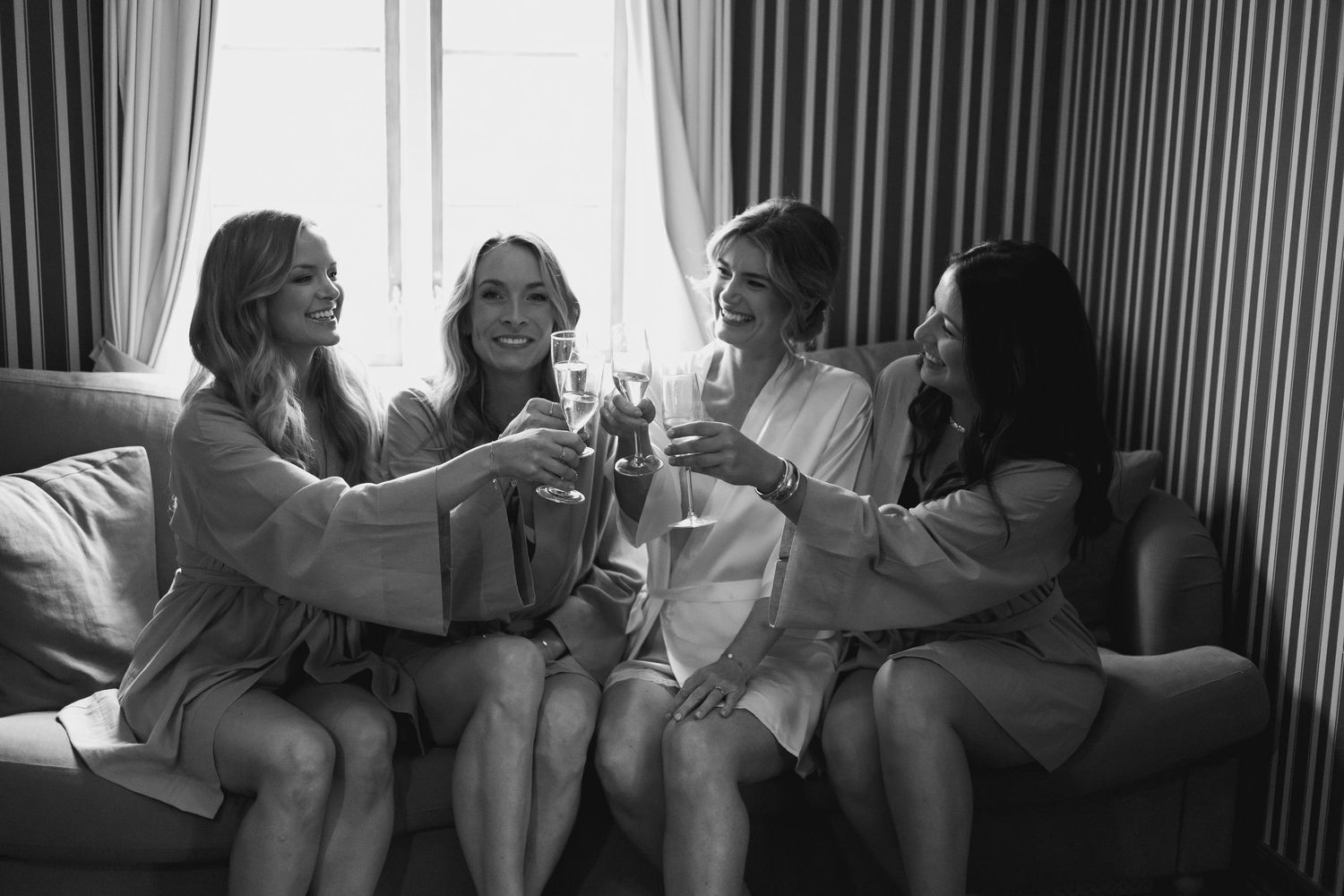 A black and white photo series showing joyful moments during wedding preparations.