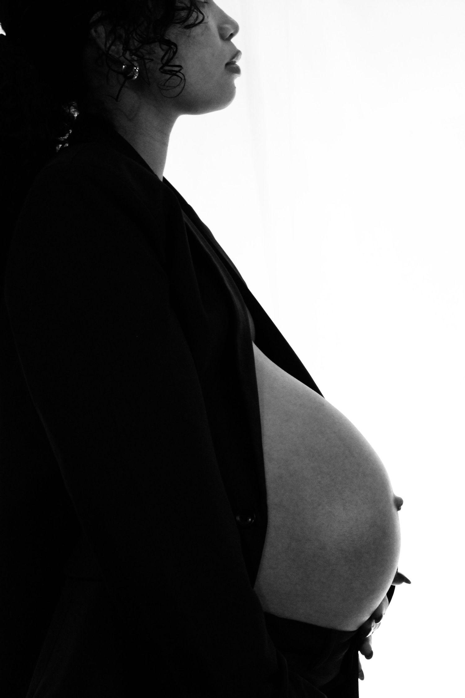 Artistic black and white profile silhouettes showing different angles of a figure against dark background.