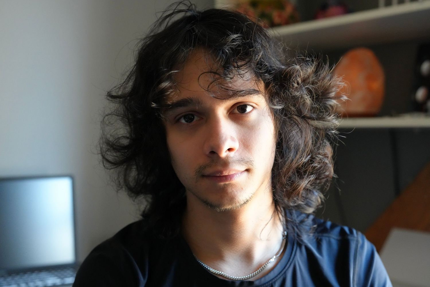 A series of candid headshots showing someone with curly dark hair in different expressions.