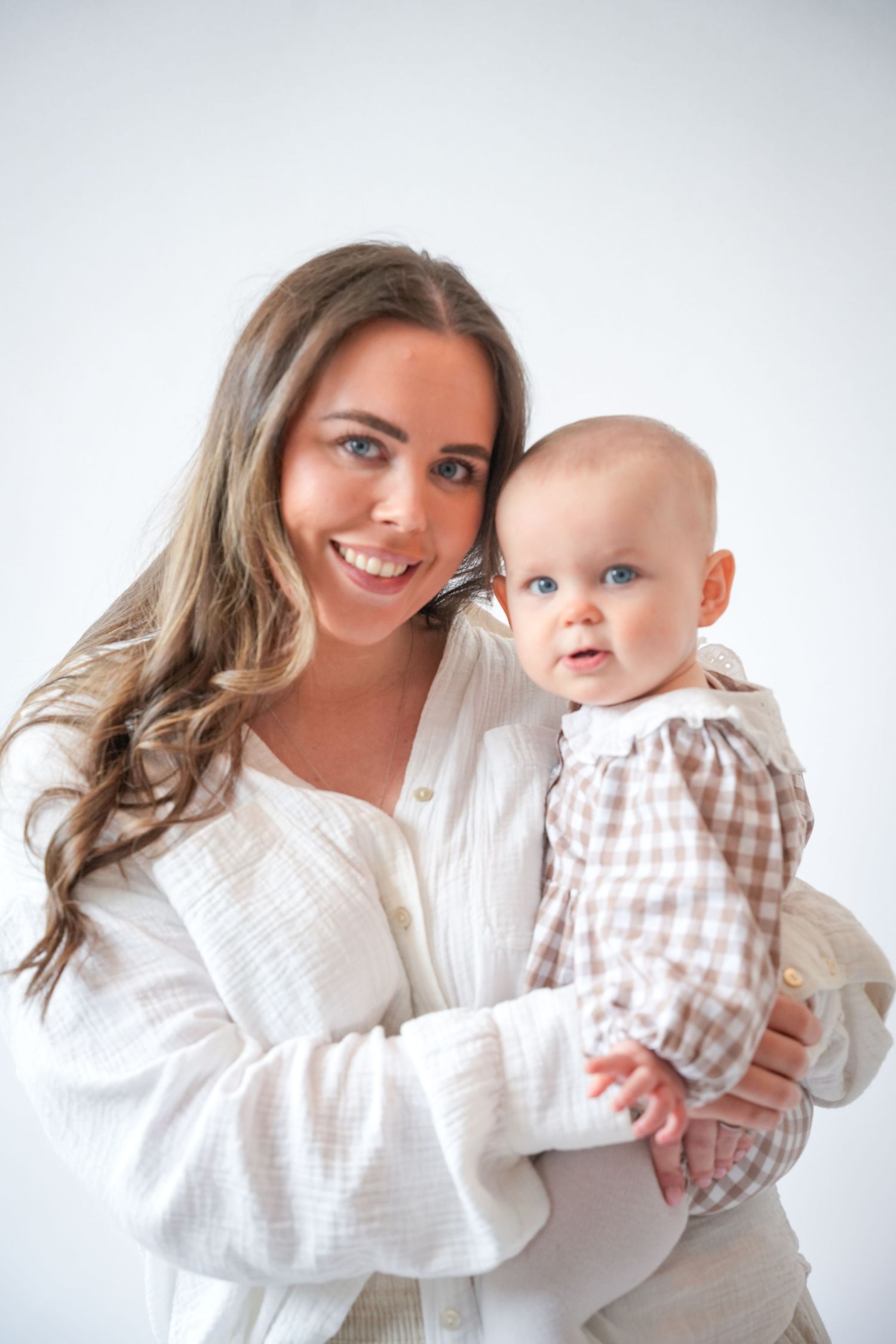 Photo of mum and baby, light, airy background with natural lighting
