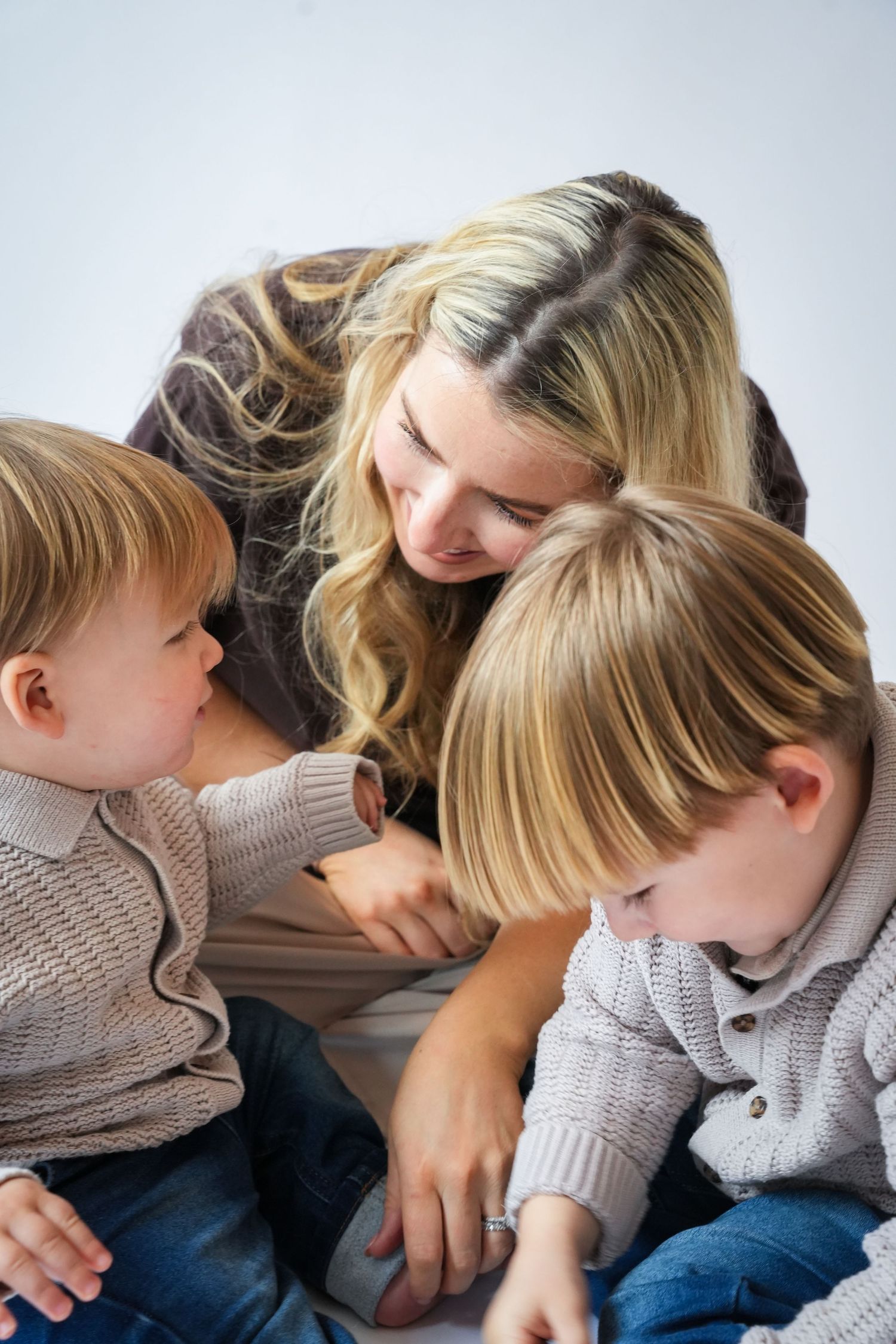 Photo of mum, toddler and baby, light, airy background with natural lighting