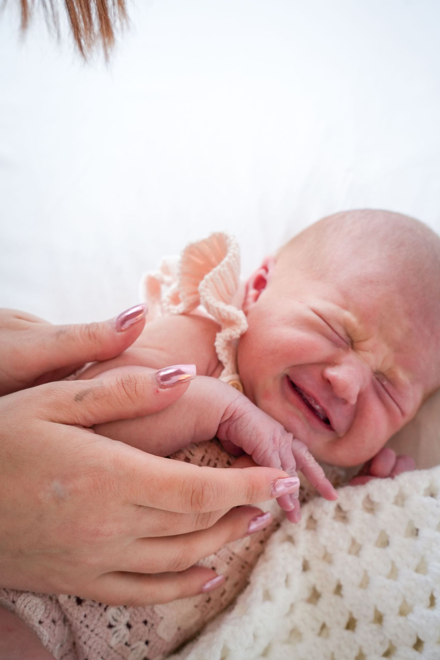 Photo of newborn baby, light, airy background with natural lighting