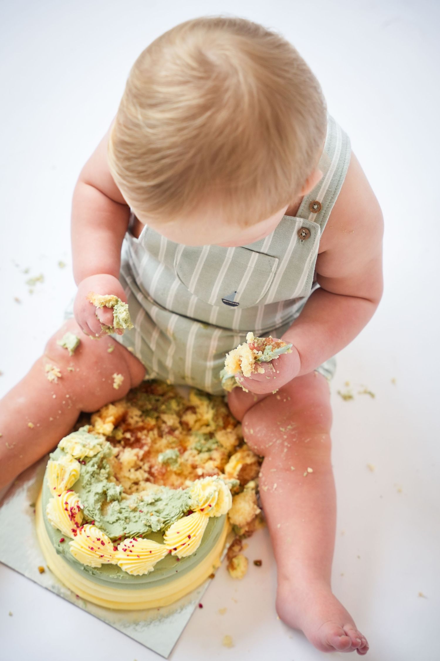 Photo of baby with cake, light, airy background with natural lighting