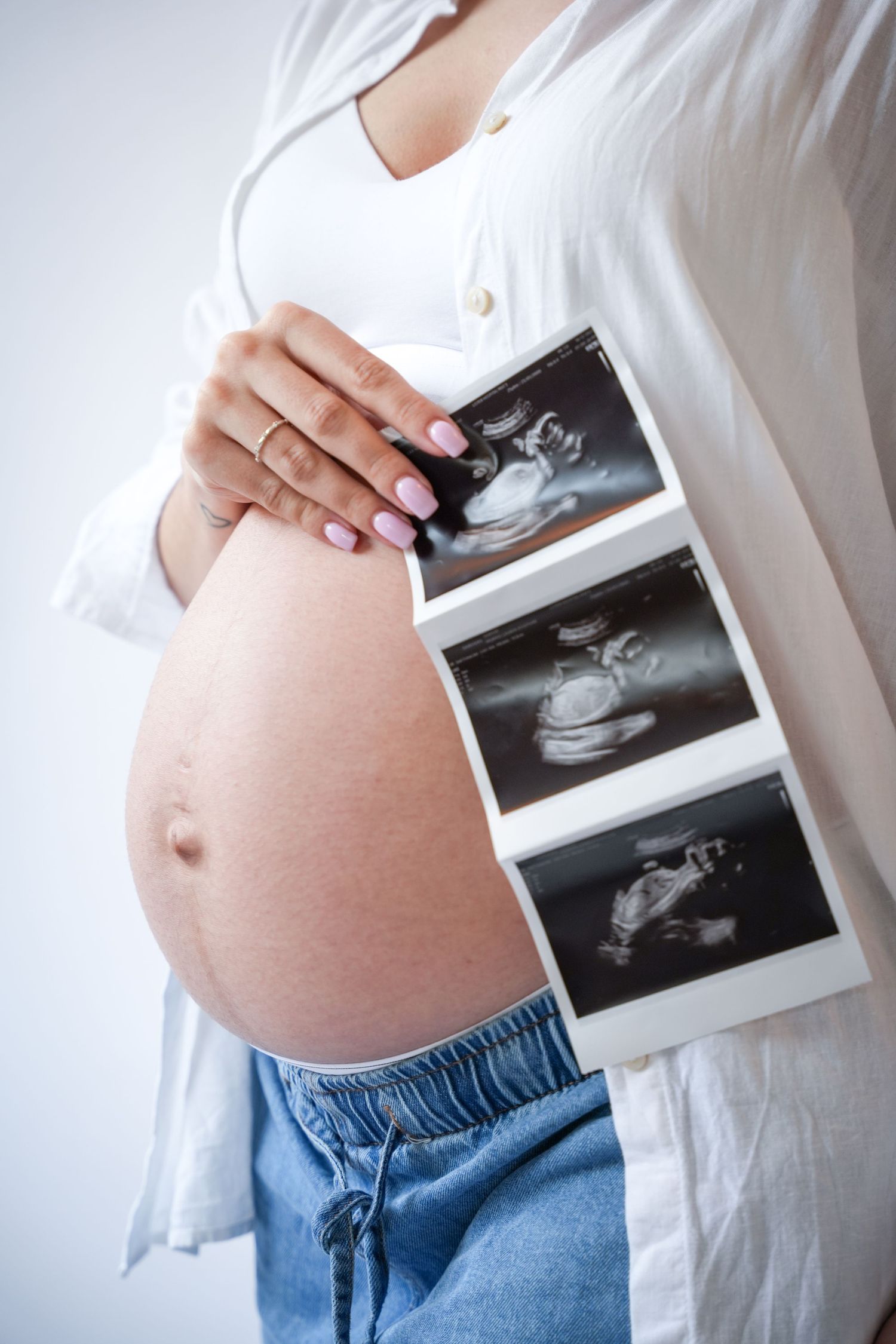 Photo of pregnancy belly, light, airy background with natural lighting