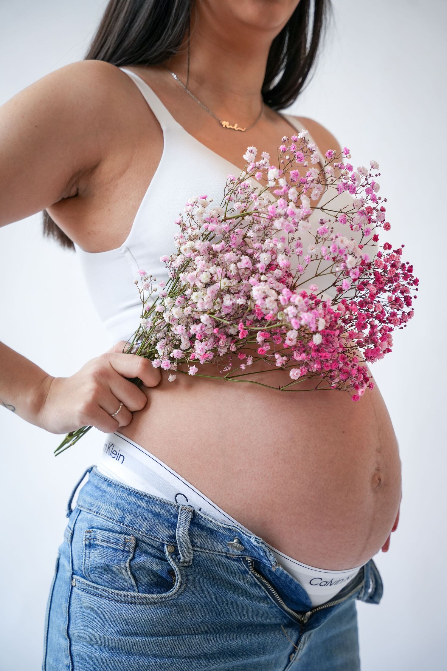 Photo of pregnancy belly, light, airy background with natural lighting