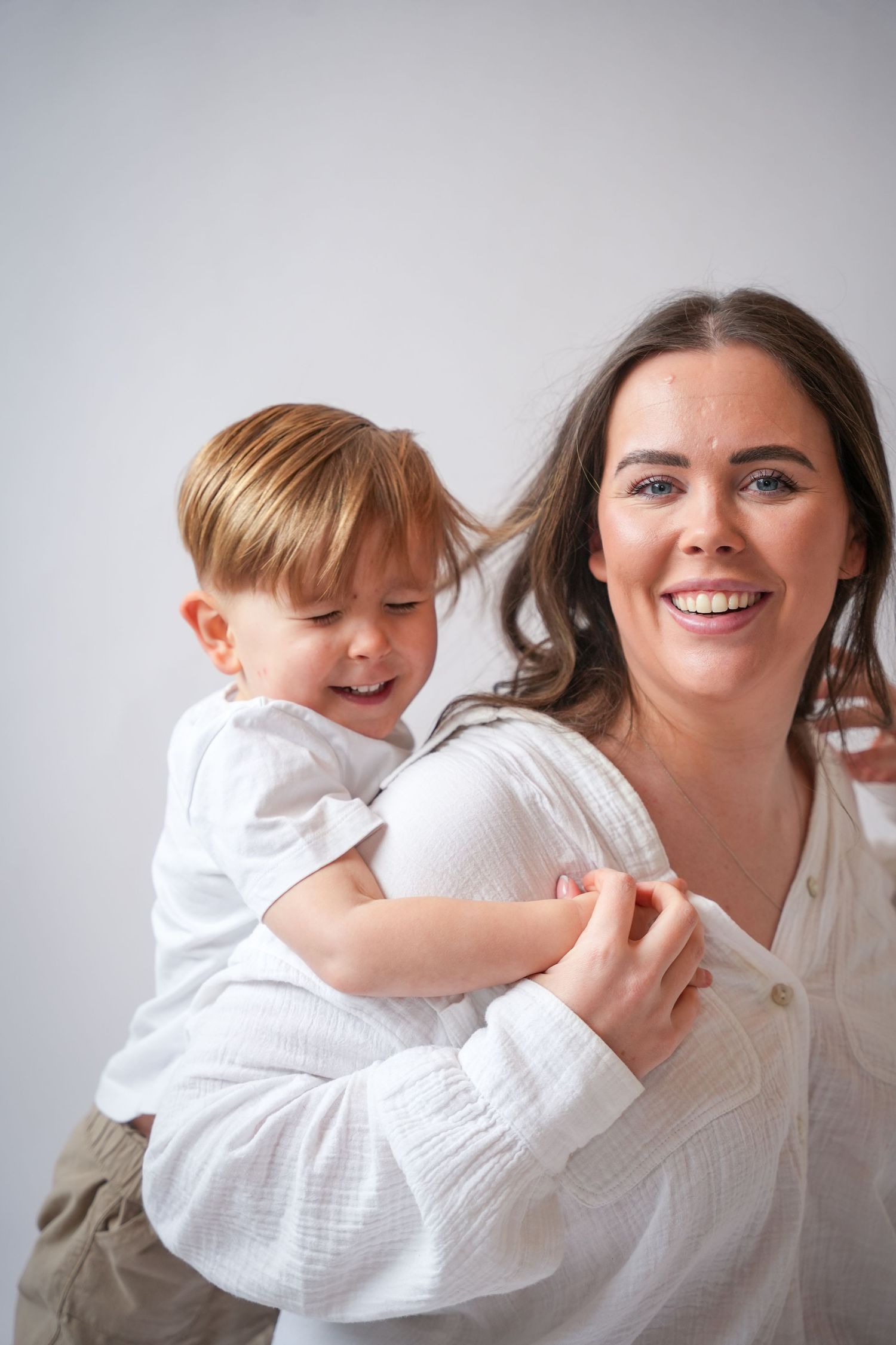Photo of mum and toddler playing, light, airy background with natural lighting