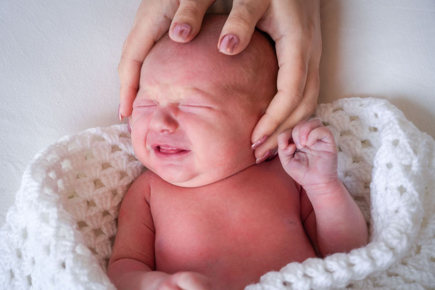 Photo of newborn baby, light, airy background with natural lighting