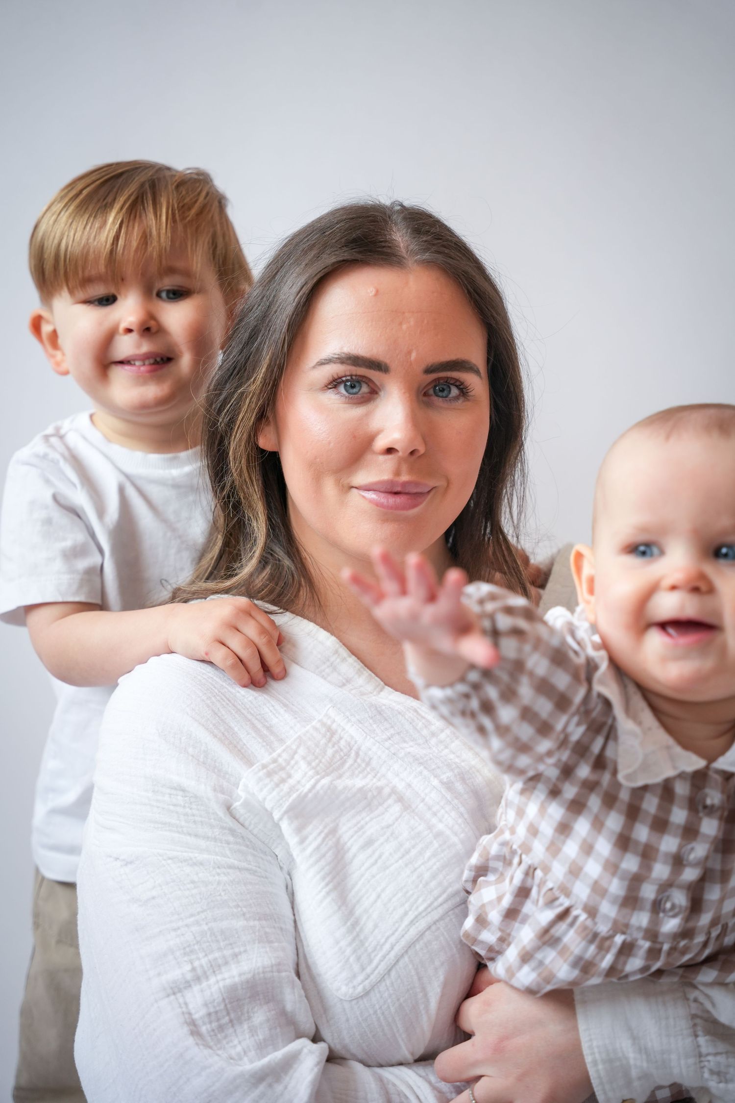 Photo of mum, toddler and baby, light, airy background with natural lighting