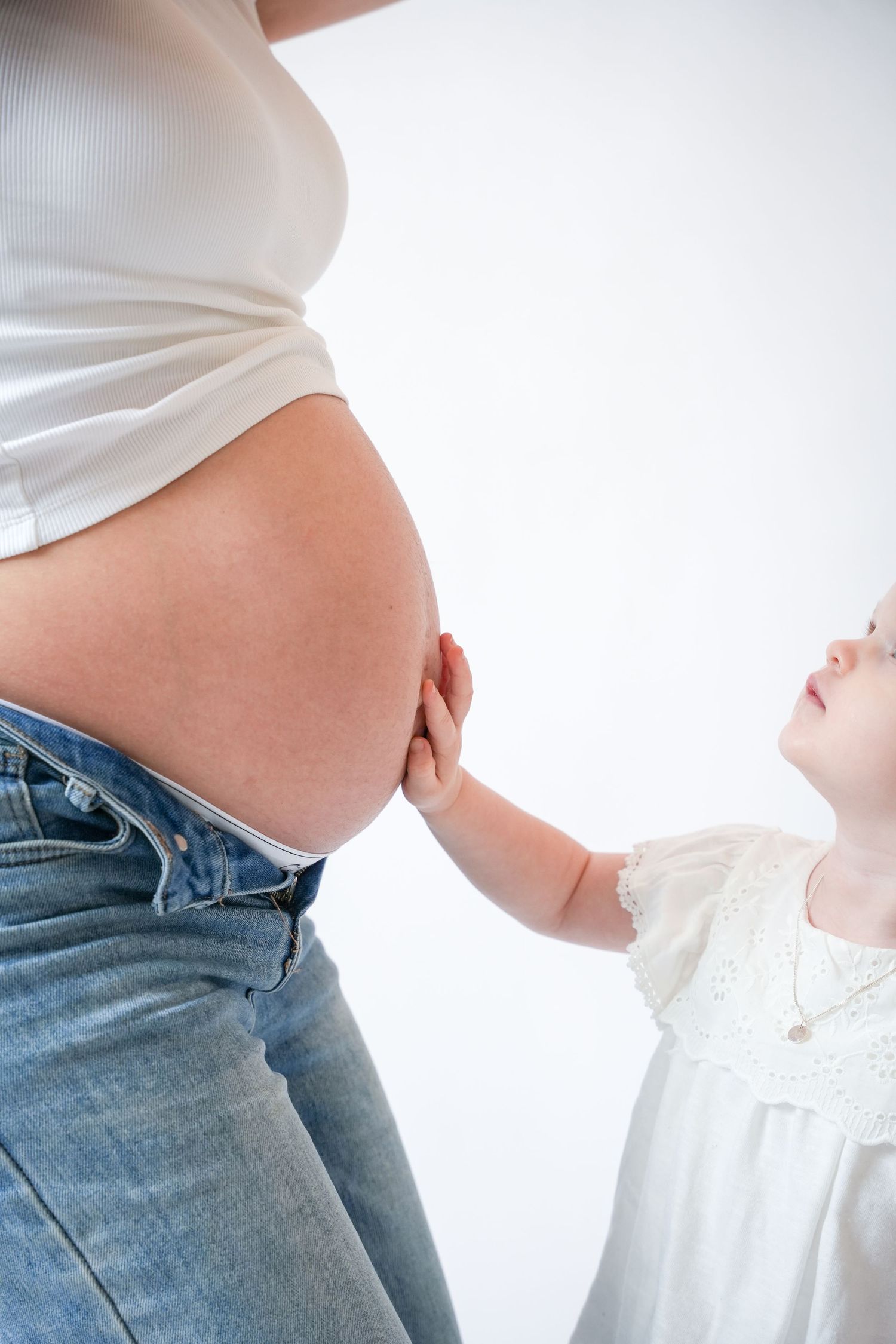Photo of pregnancy belly,  light, airy background with natural lighting