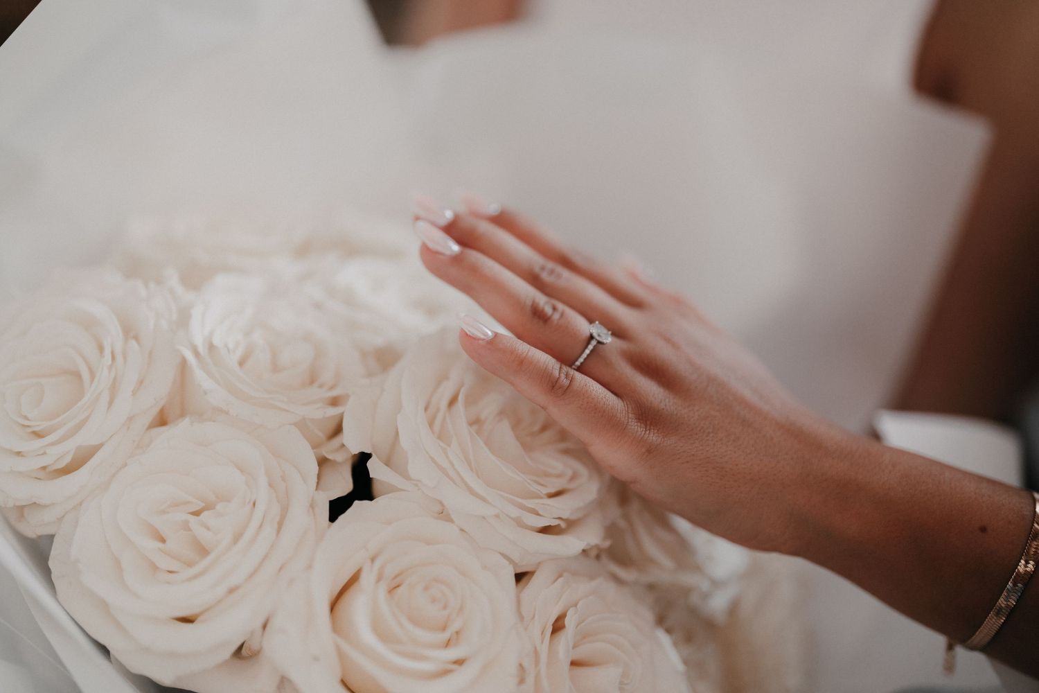 A close-up view of delicate light pink roses arranged together with soft petals and natural lighting.
