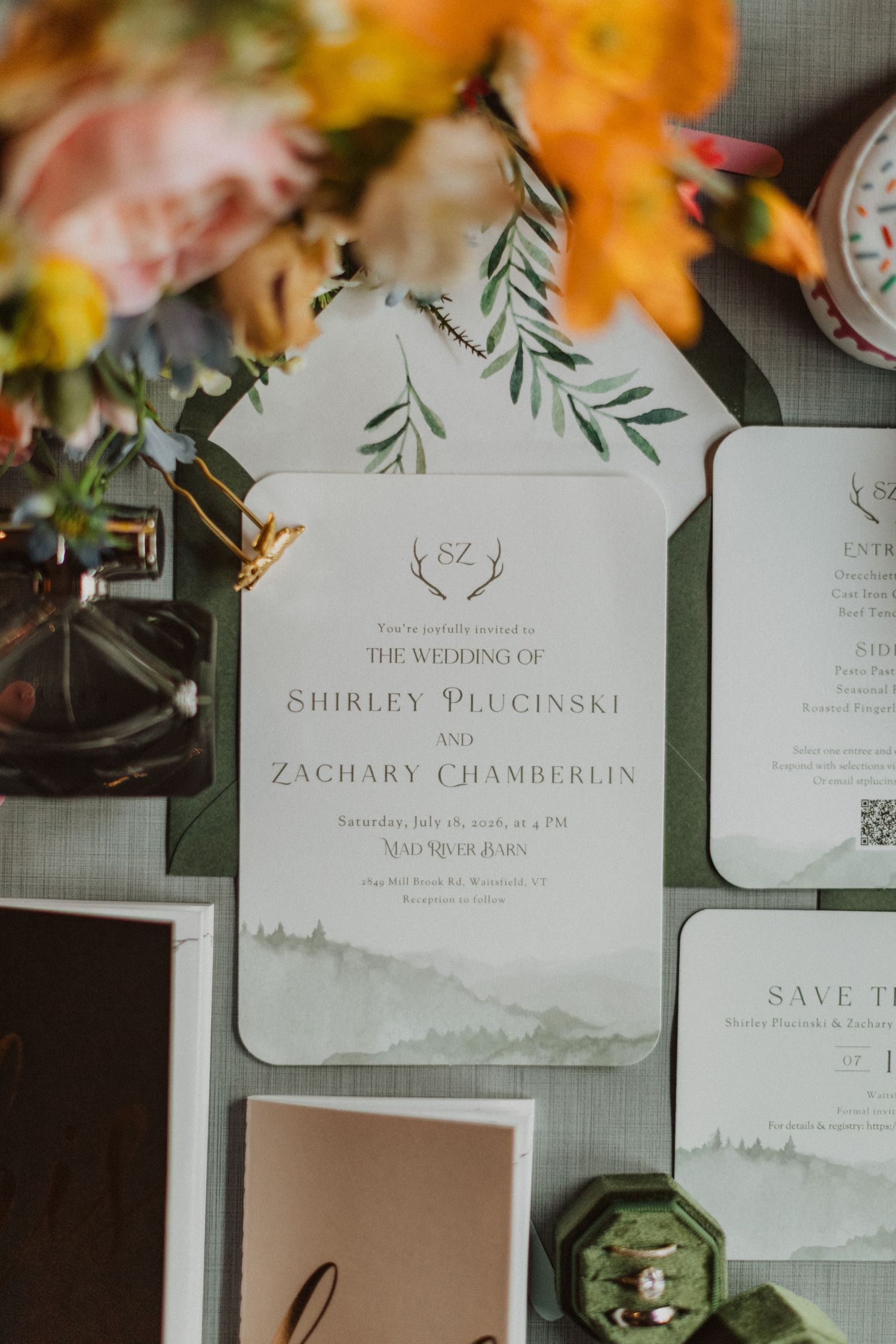 Elegant wedding invitation suite for Shirley Plucinski and Zachary Chamberlin featuring watercolor mountain and greenery details.