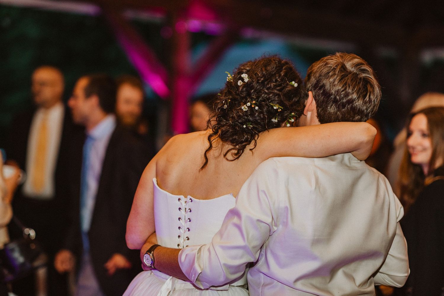 Bride and groom share an intimate first dance embrace at their wedding reception.