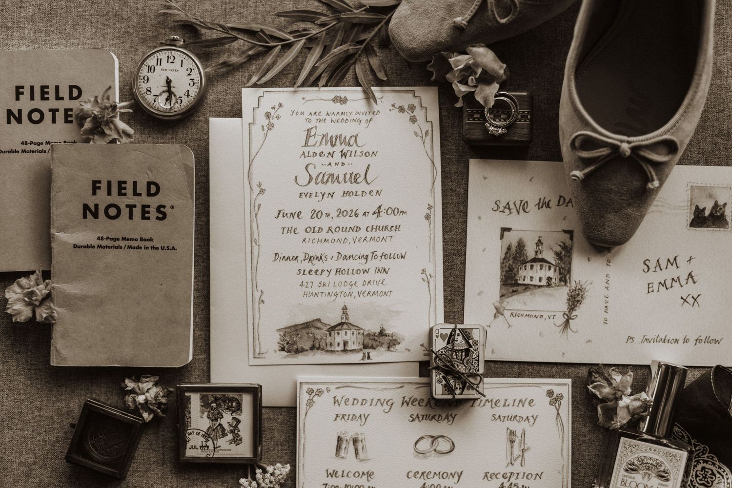 Elegant wedding stationery flatlay featuring invitations, save the date cards, and Field Notes journals in sepia tone.