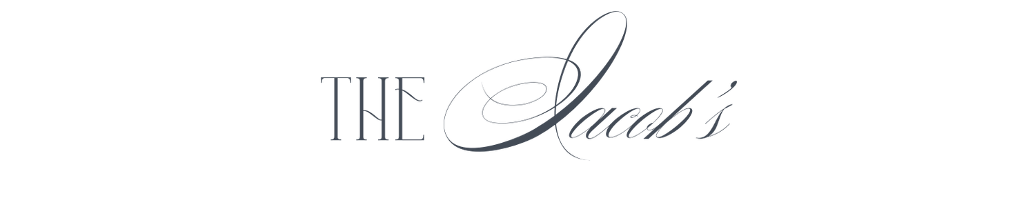 Elegant script logo reading The Jacobs in silver calligraphy on white background.