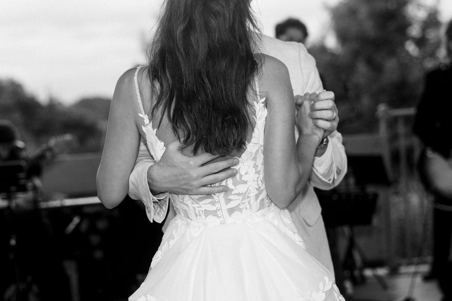 Black and white photo of bride and groom sharing their first dance at wedding reception.