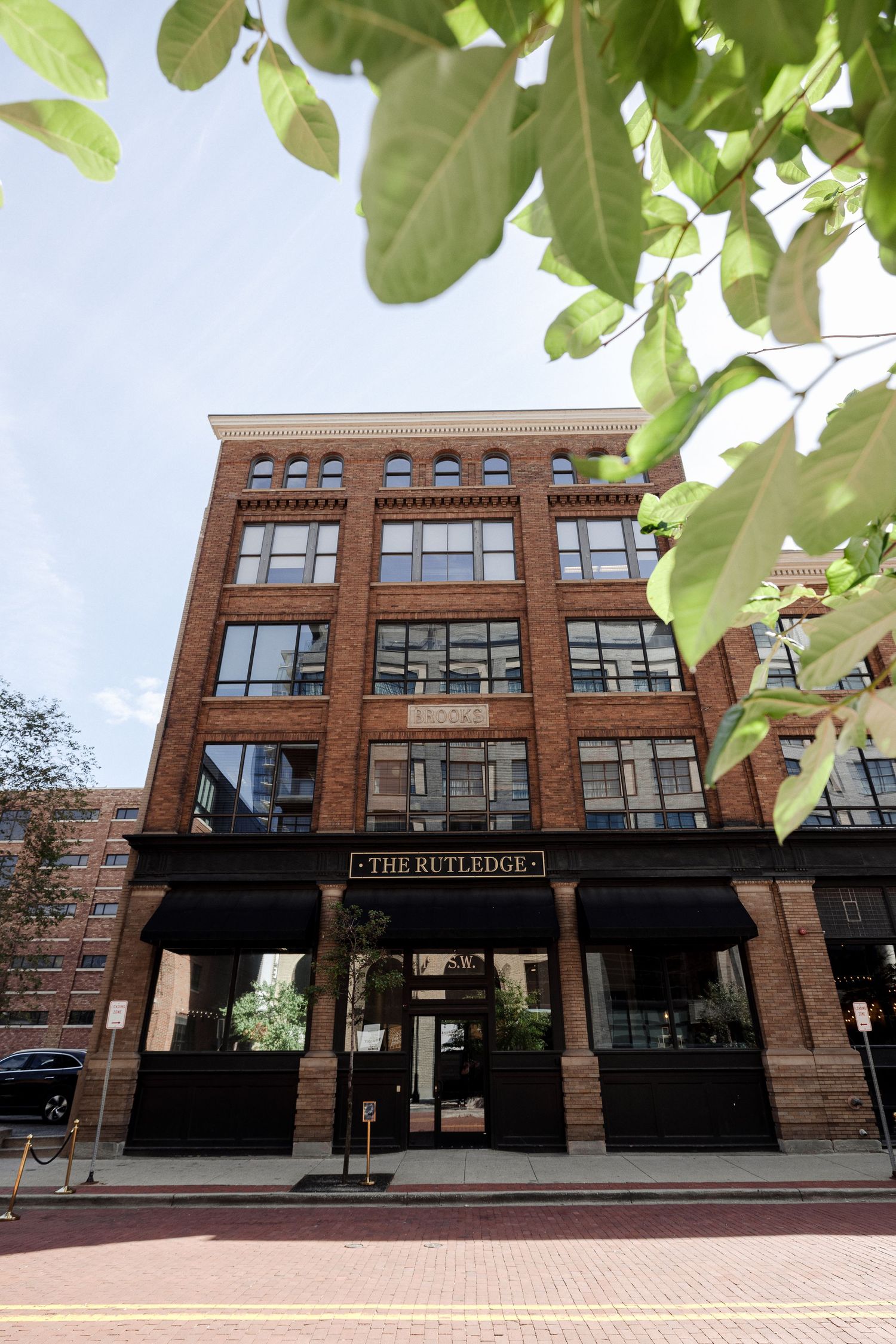 Exterior daytime view of The Rutledge, a historic brick wedding venue building.