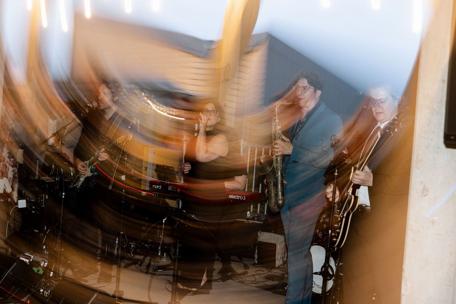 Abstract motion blur photo of a live band performing at an event.