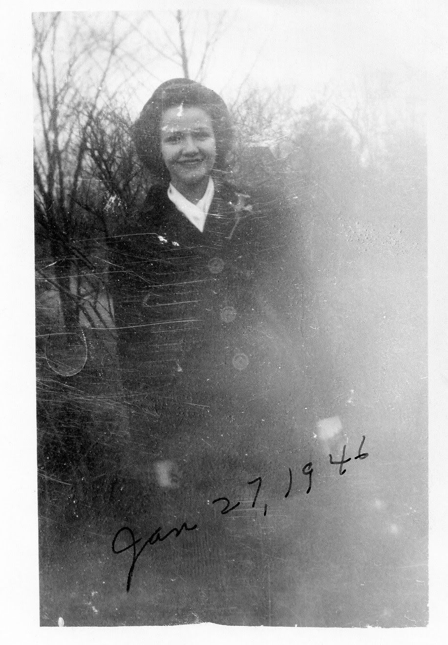 Vintage black and white photo of a smiling woman outdoors, dated January 27, 1946.