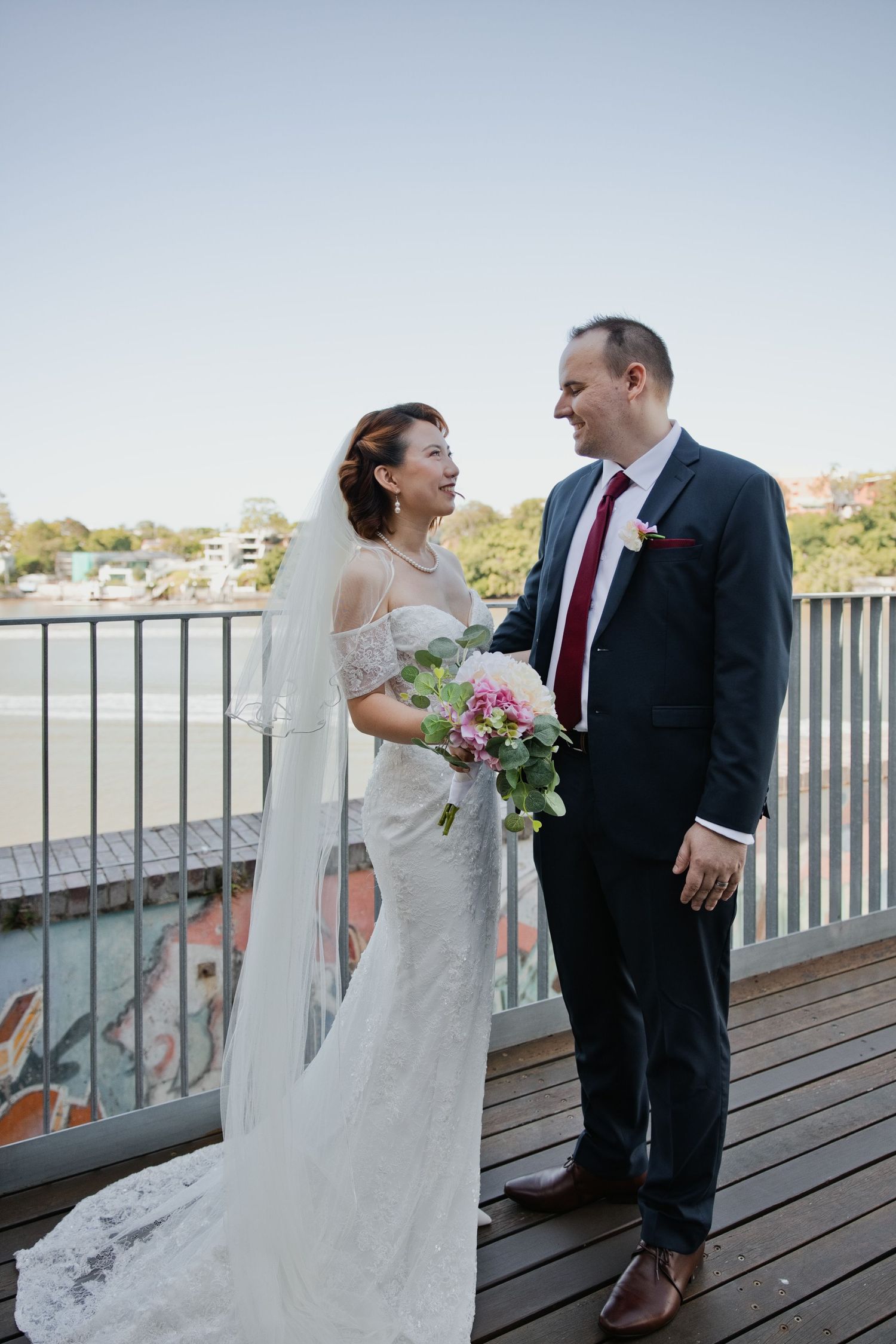 portrait of couple standing together looking at eachother