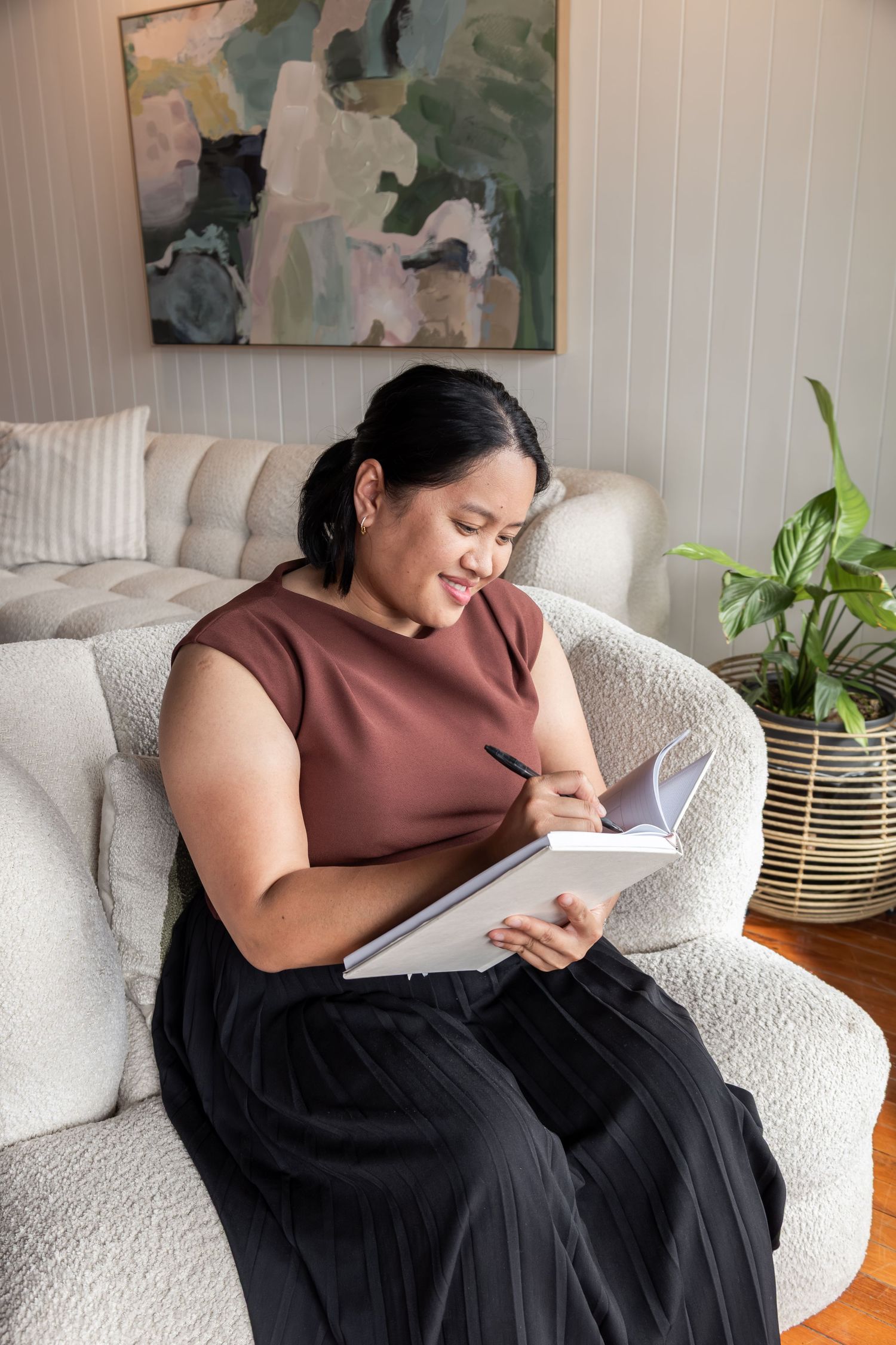branding image. lady on couch with notepad and pen