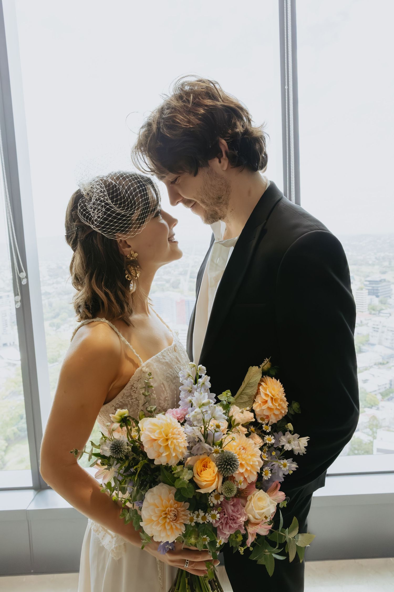 portrait of couple standing together looking at eachother
