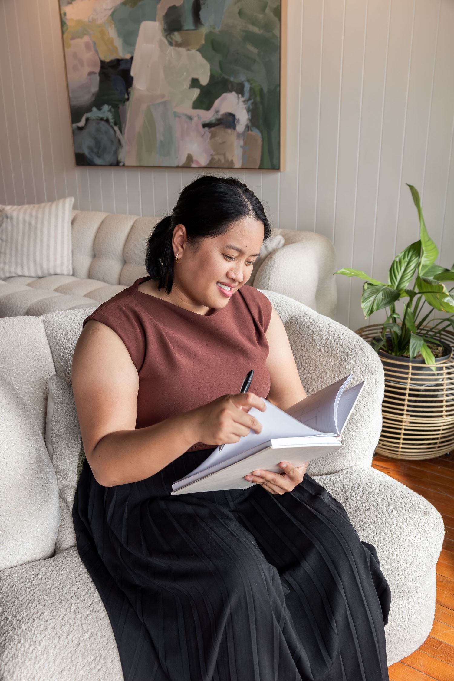 branding image. lady on couch with notepad and pen