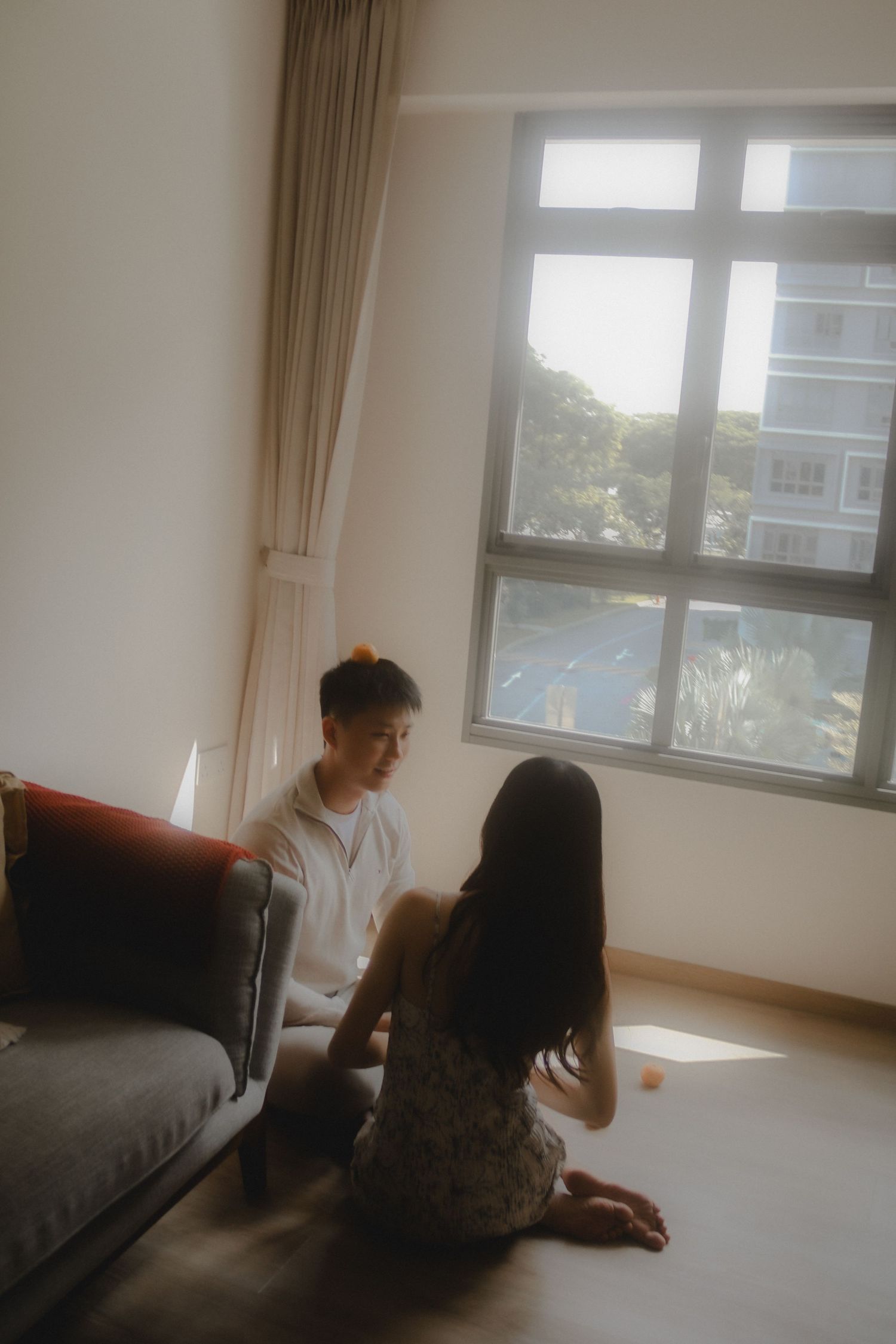 In-home couple photoshoot in Singapore with warm, natural light and storytelling focus