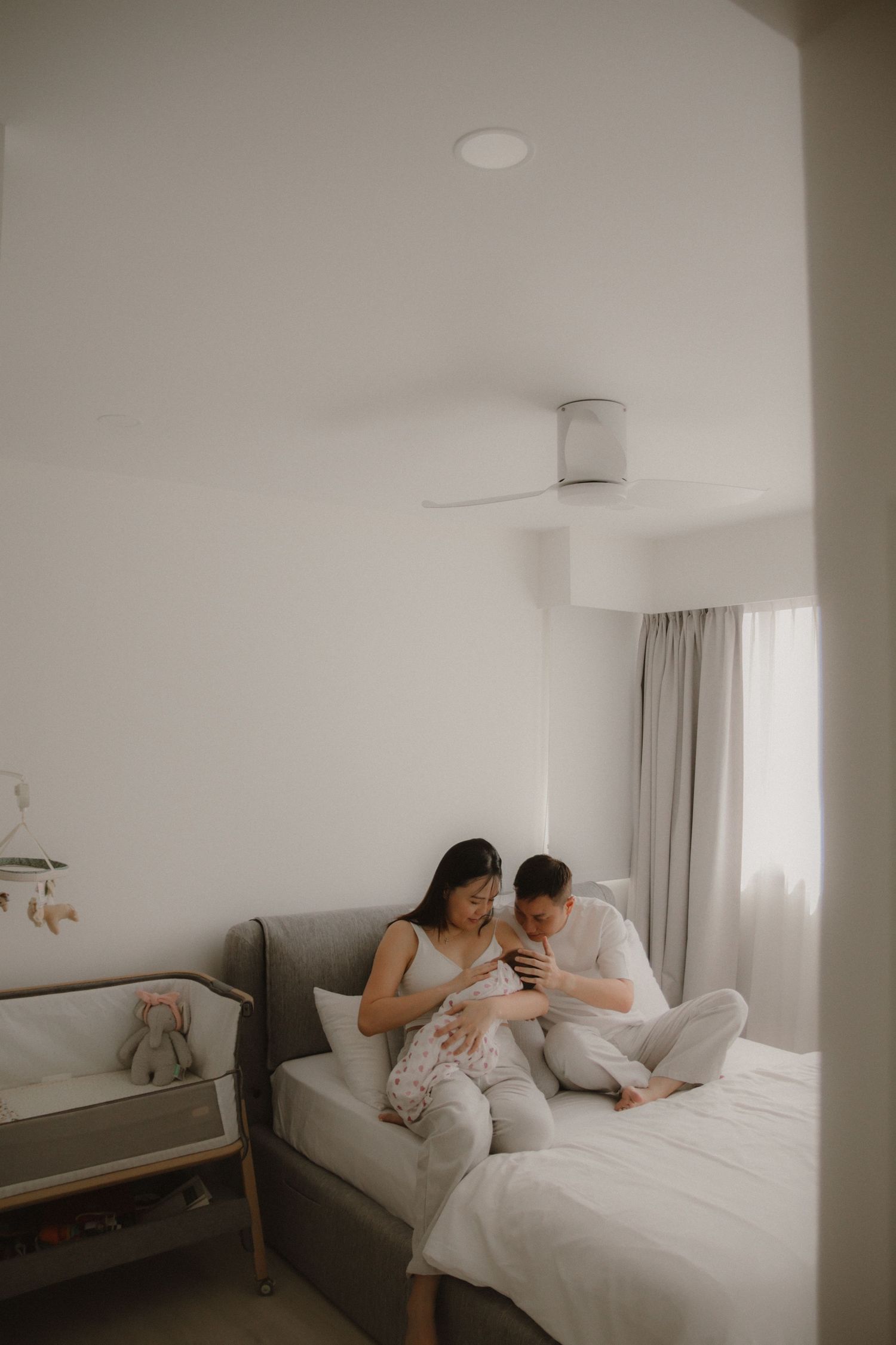 In-home newborn photography in Singapore documenting early days with soft natural light at home