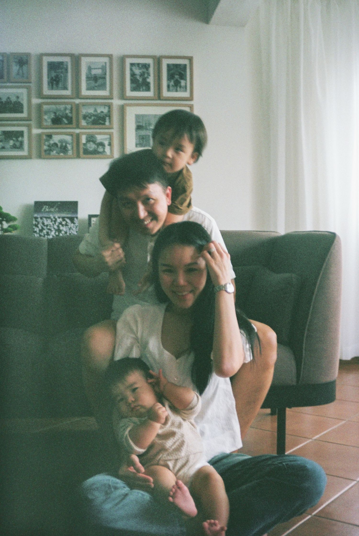In-home family photoshoot in Singapore capturing candid moments between parents and children at home, film photography