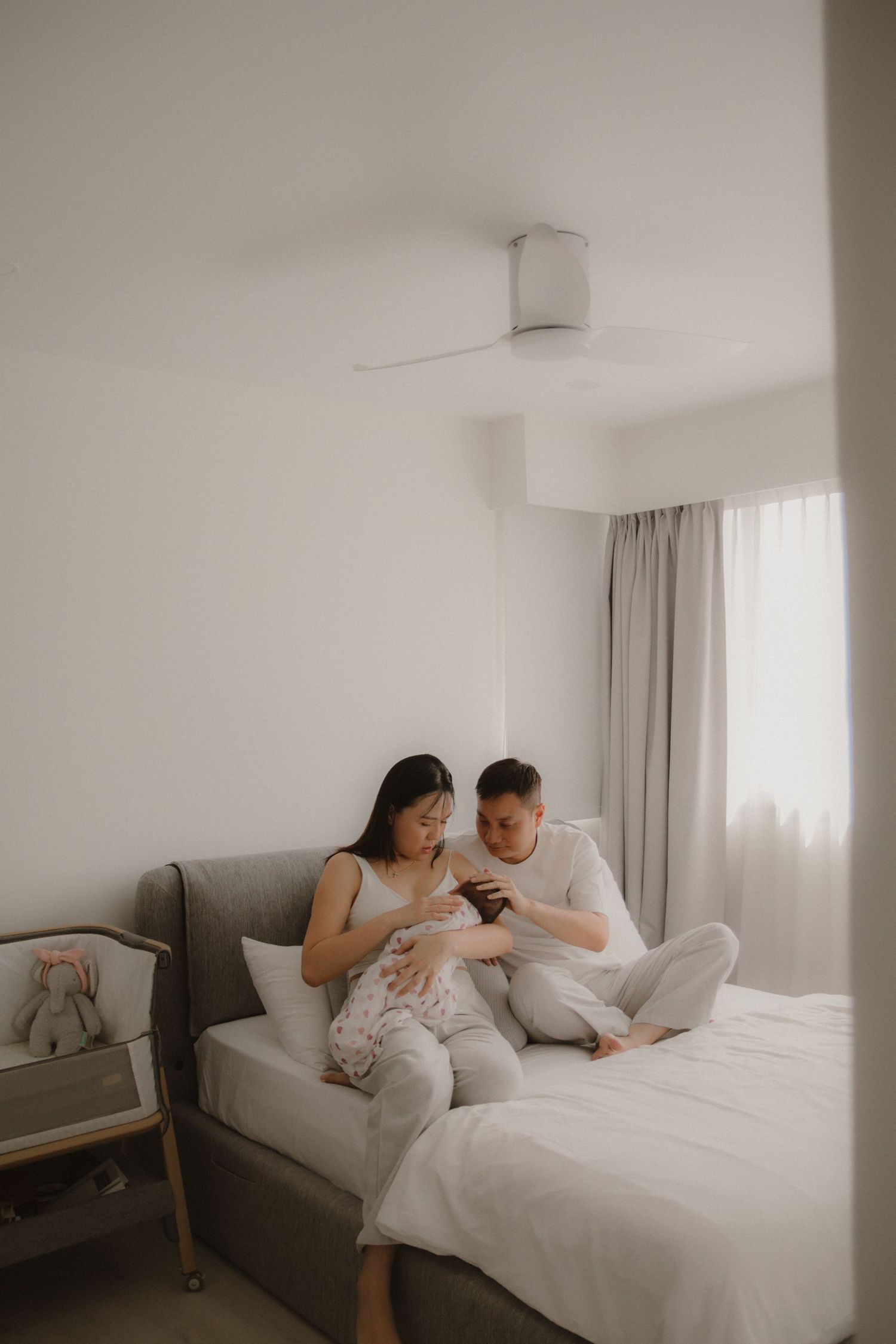 In-home newborn photography in Singapore documenting early days with soft natural light at home